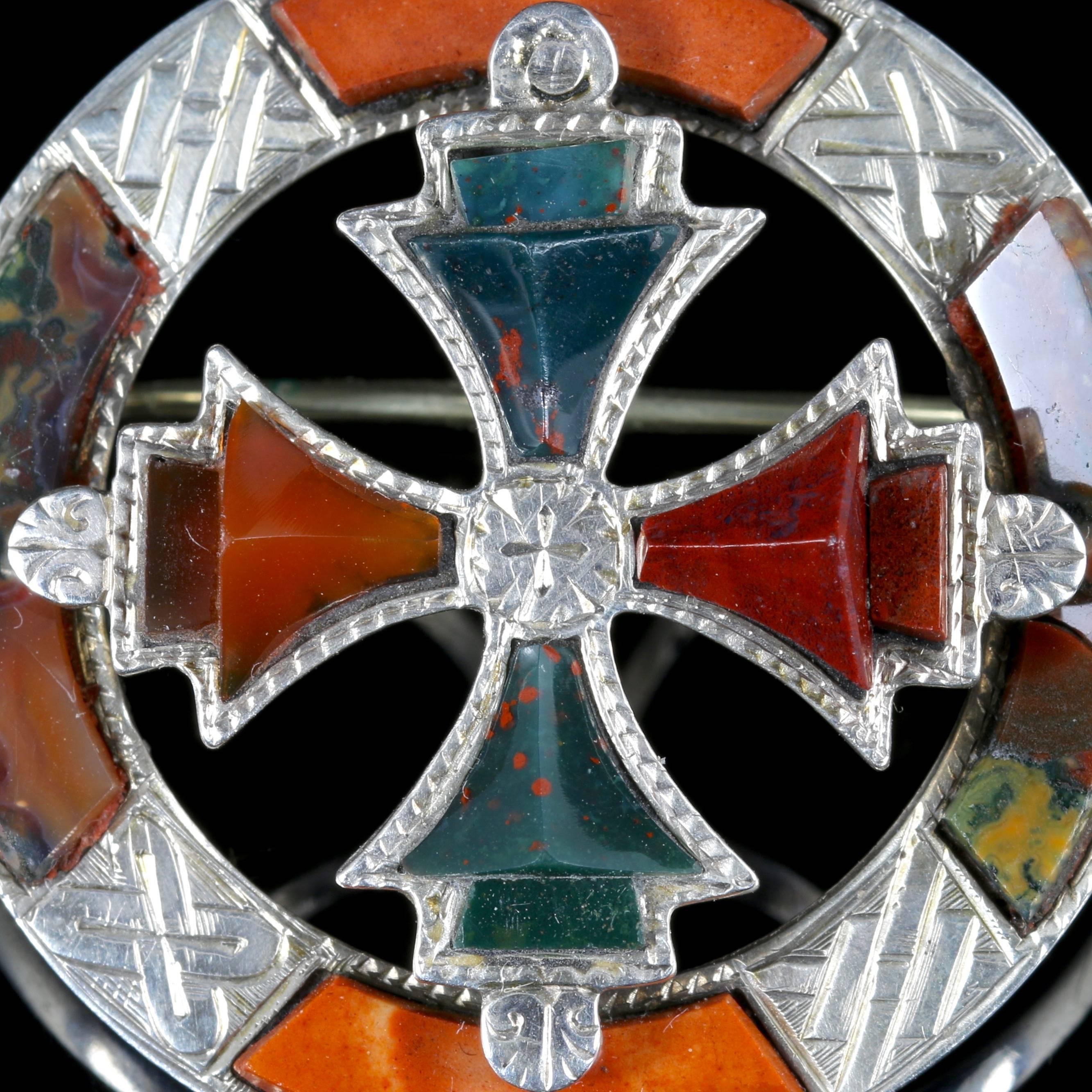 This is a fabulous Victorian large Scottish Silver Agate brooch.

Circa 1860.

Set with a large Celtic Agate cross in the centre.

Scottish jewellery was made popular by Queen Victoria as it became a souvenir of her trips to Scotland. 

From the mid