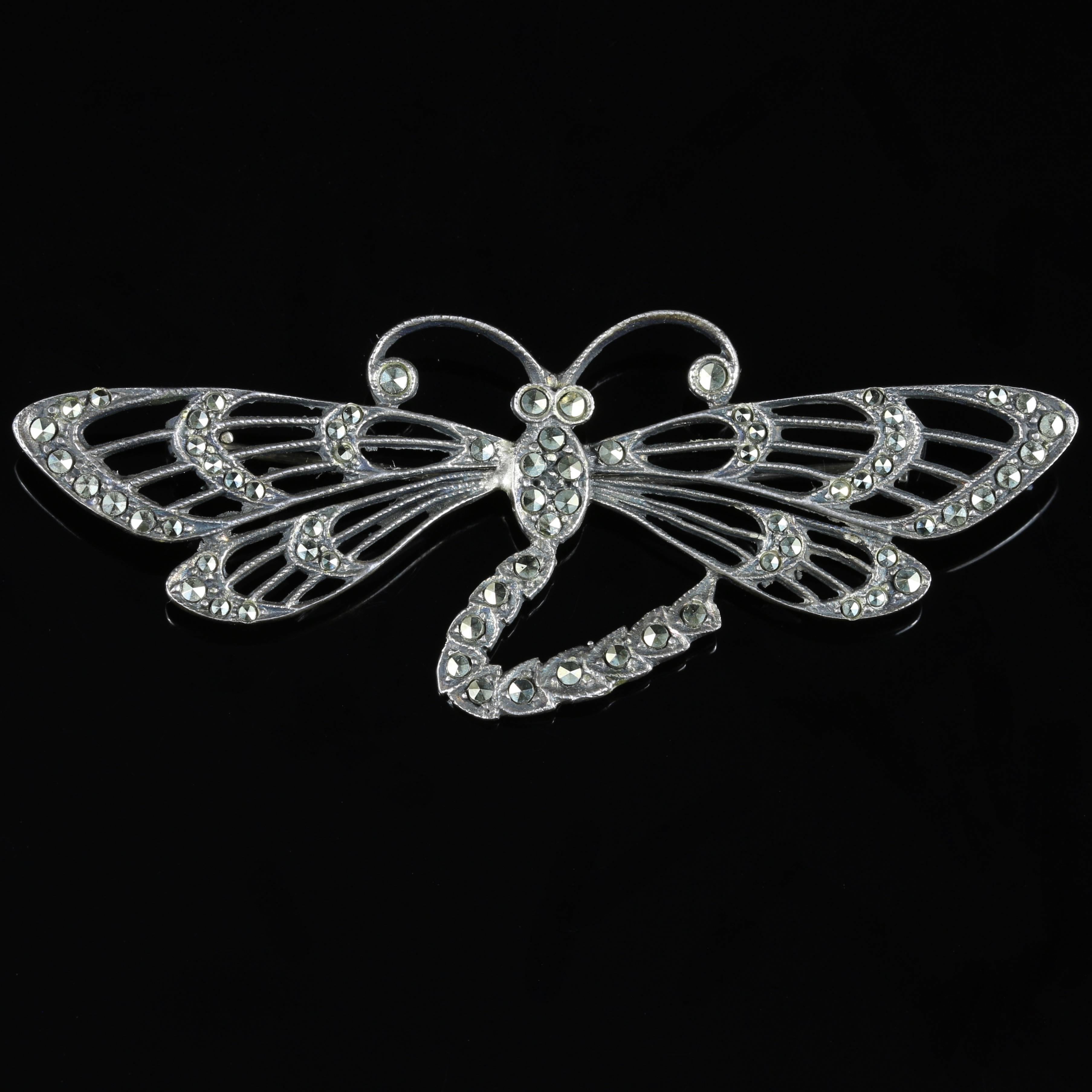 This fabulous genuine Antique large sterling Silver dragonfly brooch is adorned with Marcasites.

Circa 1920

This breath taking dragonfly brooch has fabulous detail and encrusted with Marcasites

Marcasite jewellery has been made since the time of