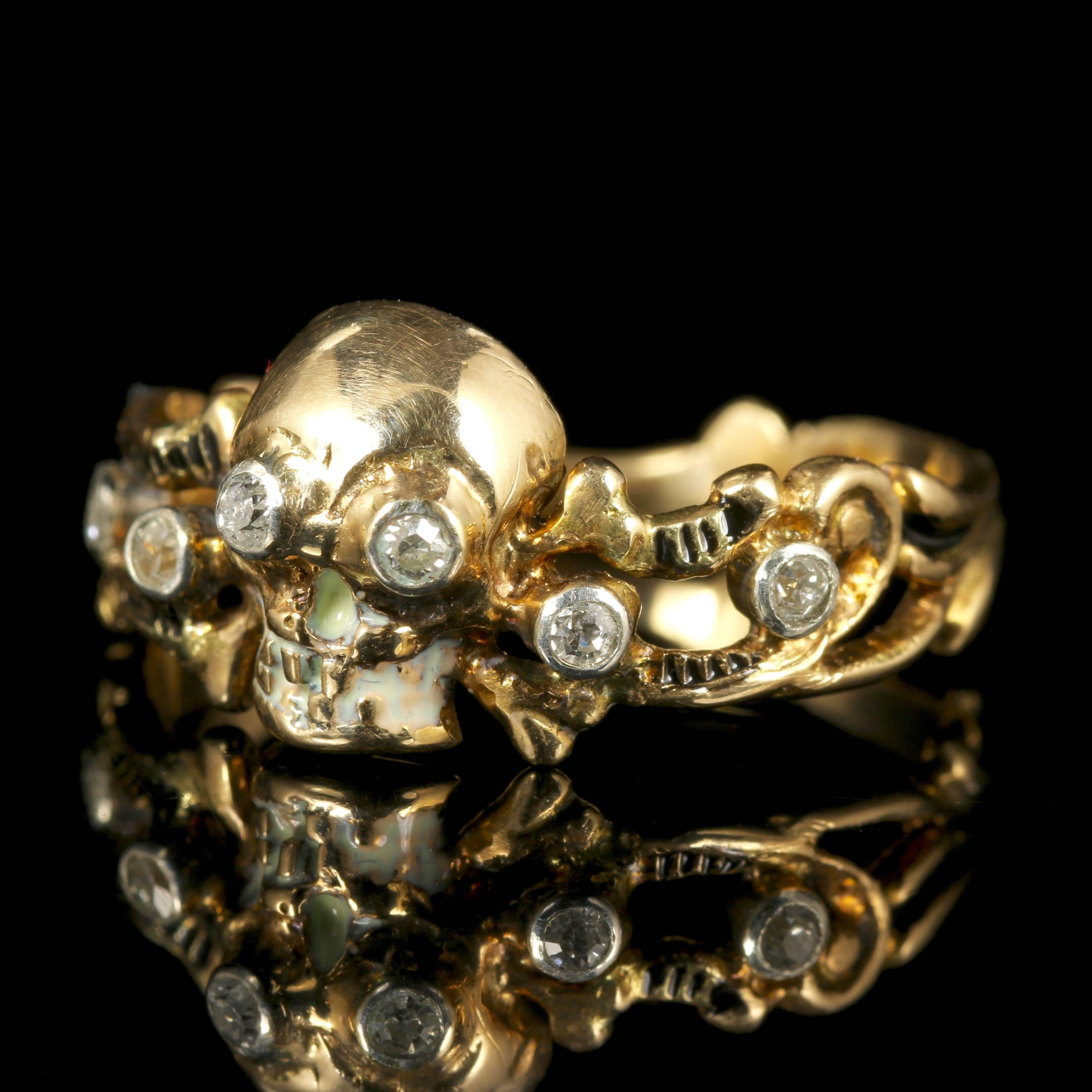 This fabulous 18ct Yellow Gold Memento Mori Diamond Skull and cross bone ring is fabulous.

The skull and crossbones are set along the central gallery of the ring with an Enamel chin.

Skull jewellery (Memento Mori) is very collectable. 

Memento