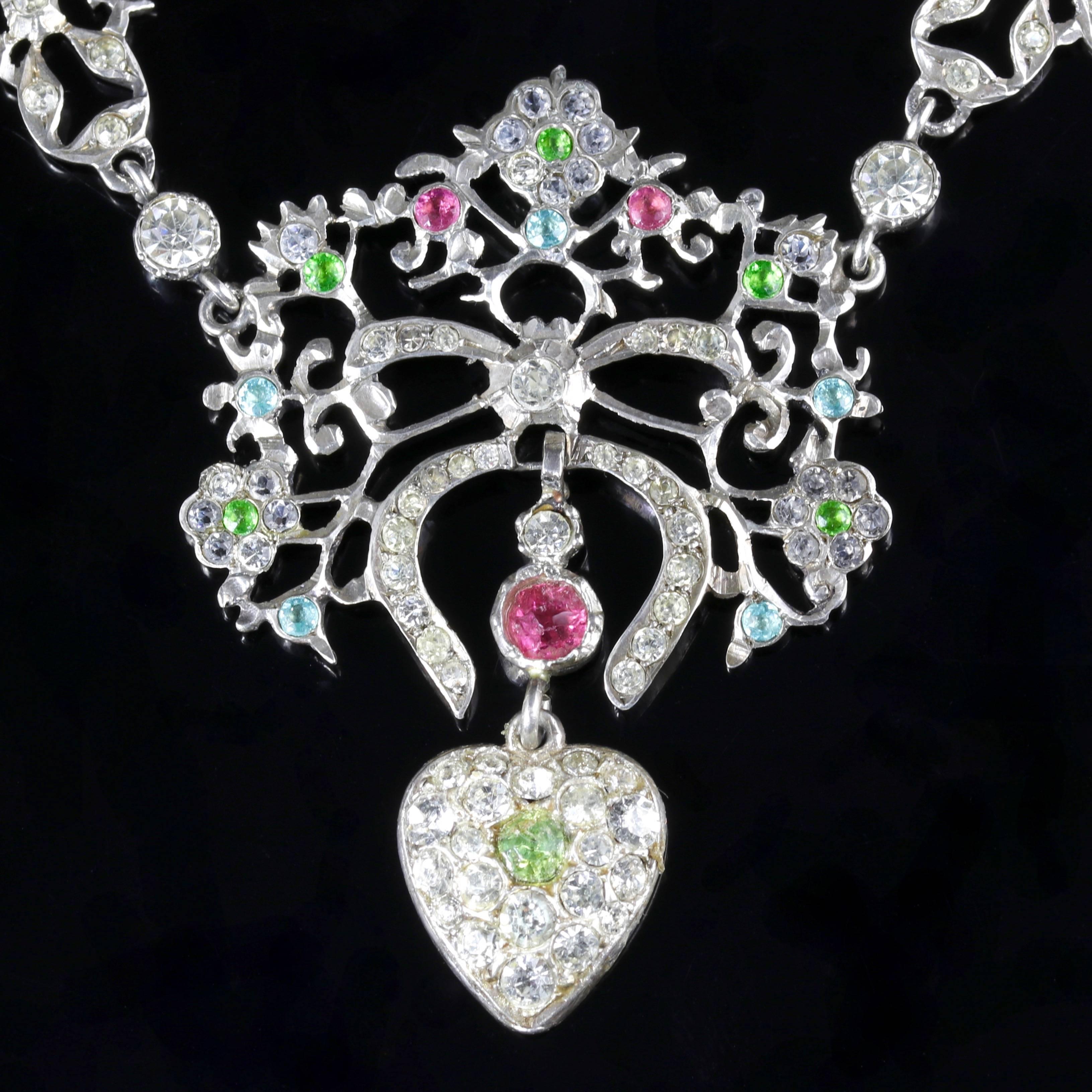 This genuine Victorian Sterling Silver Suffragette necklace is stunning.

Circa 1900.

Set with beautiful old cut Paste Stones that lead to a lovely heart pendant dropper.

Old Cut Paste Stones sparkle just like Diamonds, captivating the allure of