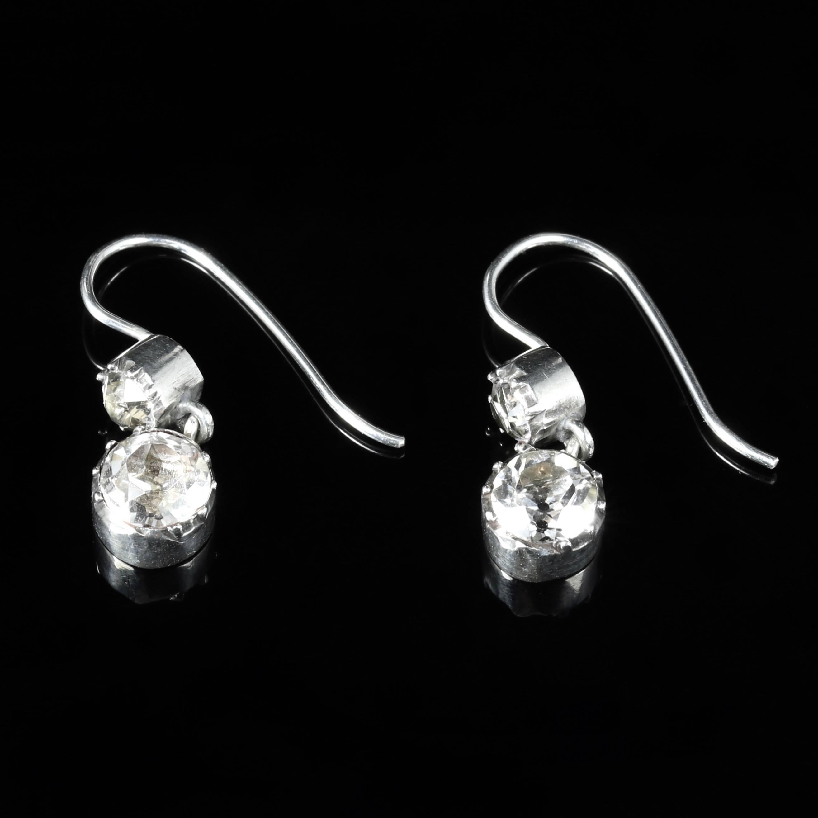 These fabulous double drop earrings are set in Sterling Silver with lovely Paste stones.

Circa 1800.

Beautiful old cushion cut Paste stones adorn these lovely earrings.

Paste is a heavy, very transparent flint glass that stimulates the fire and