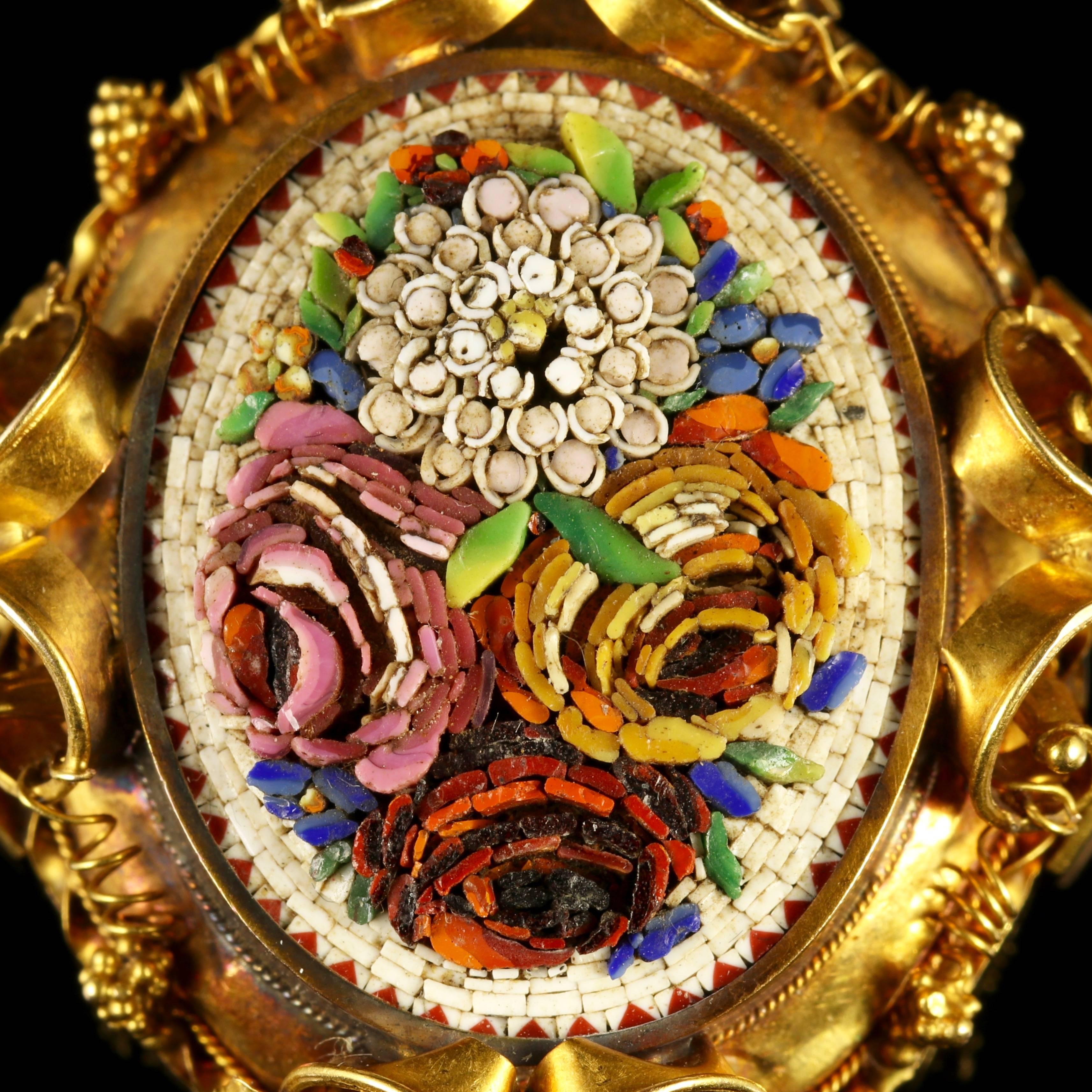 This genuine Victorian 18ct Yellow Gold Micro-mosaic locket pendant is stunning.

A beautiful piece of victorian history, Circa 1860.

The Micro-mosaic depicts a bouquet of flowers in a variety of vibrant colours with beautiful twisting ribbon