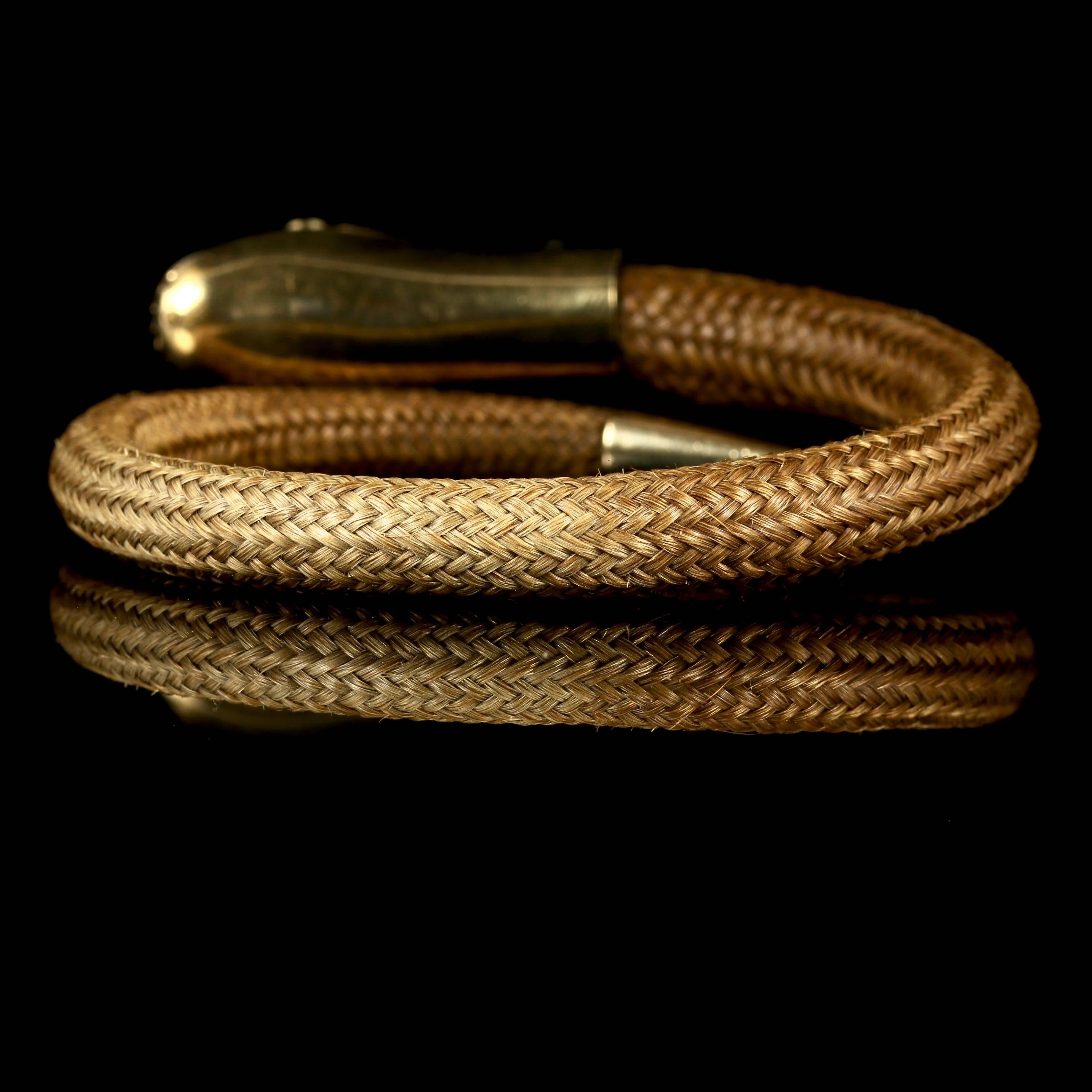 For more details please click continue reading below..

This is a genuine Georgian original 18ct Yellow Gold mourning hair Snake bangle, which is circa 1780.

The head is beautifully engraved all round, set with Cabochon Garnet eyes. 

Set in 18ct