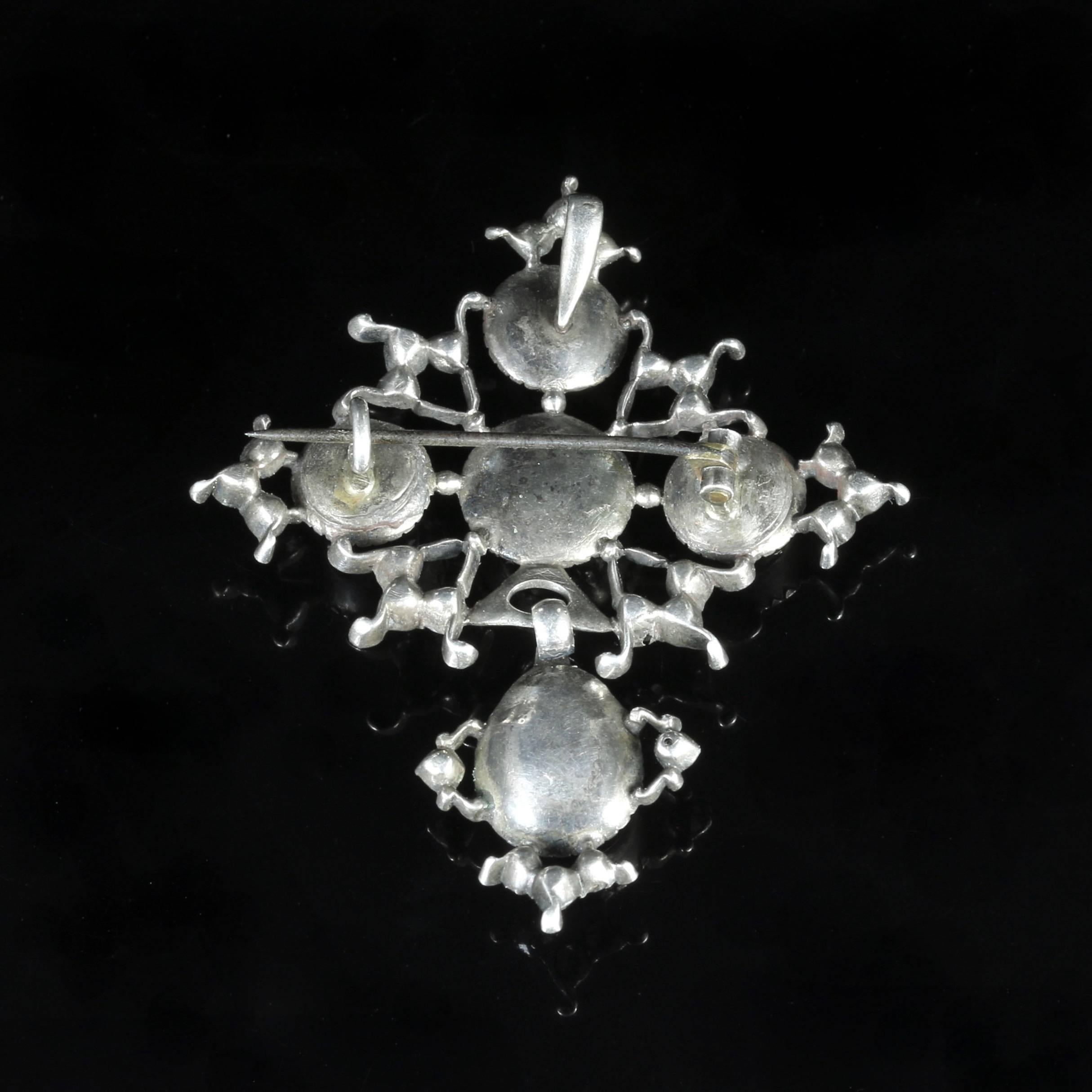 This genuine antique Sterling Silver Paste pendant brooch is circa 1800.

The large old cut Paste stones are foiled back and genuine to the pendant brooch.

It has a closed backed gallery which was typical in the Georgian era.

The pendant dropper