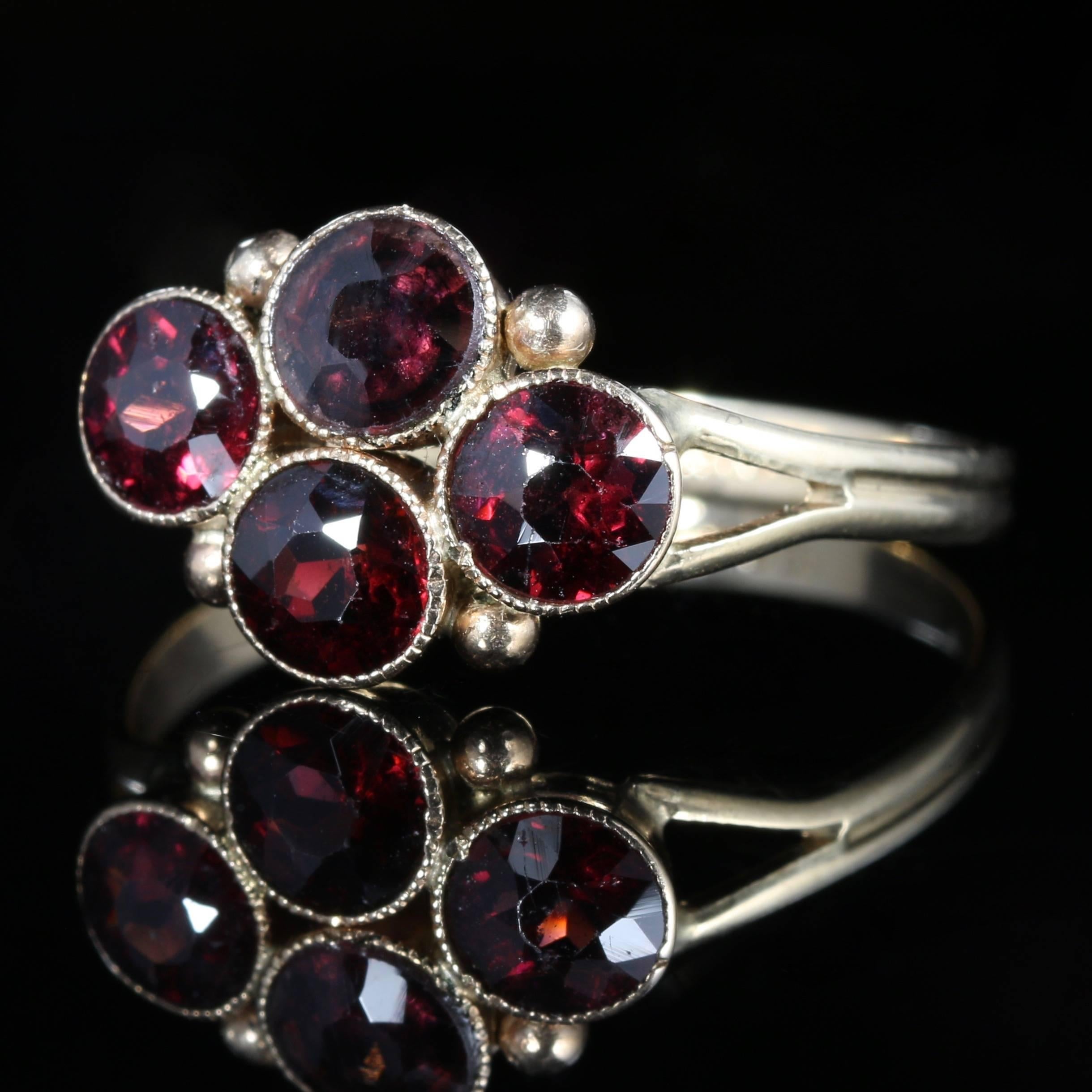 This fabulous Victorian 9ct Yellow Gold ring is set with four beautiful faceted almandine Garnets. Stamped 9ct

Almandine Garnets are a type of Garnet which boasts a deep red colour inclining to purple.

The Garnet is a stone of purity and truth as