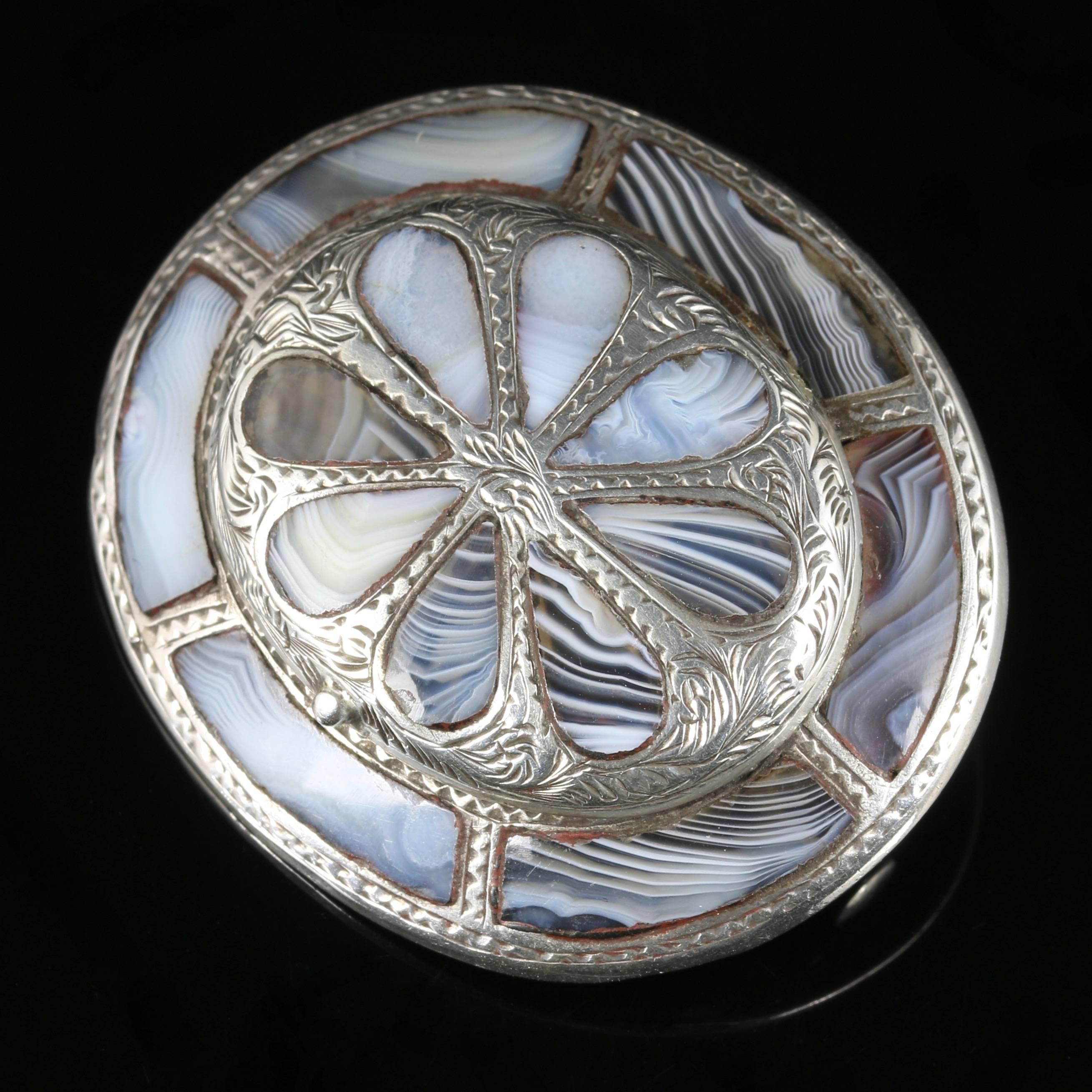 This fabulous Victorian Sterling Silver Scottish Agate brooch is exquisite. Circa 1860

Set with a lovely locket on the top which opens to display a glass window where you can add your own history.

A superb quality brooch that is very well