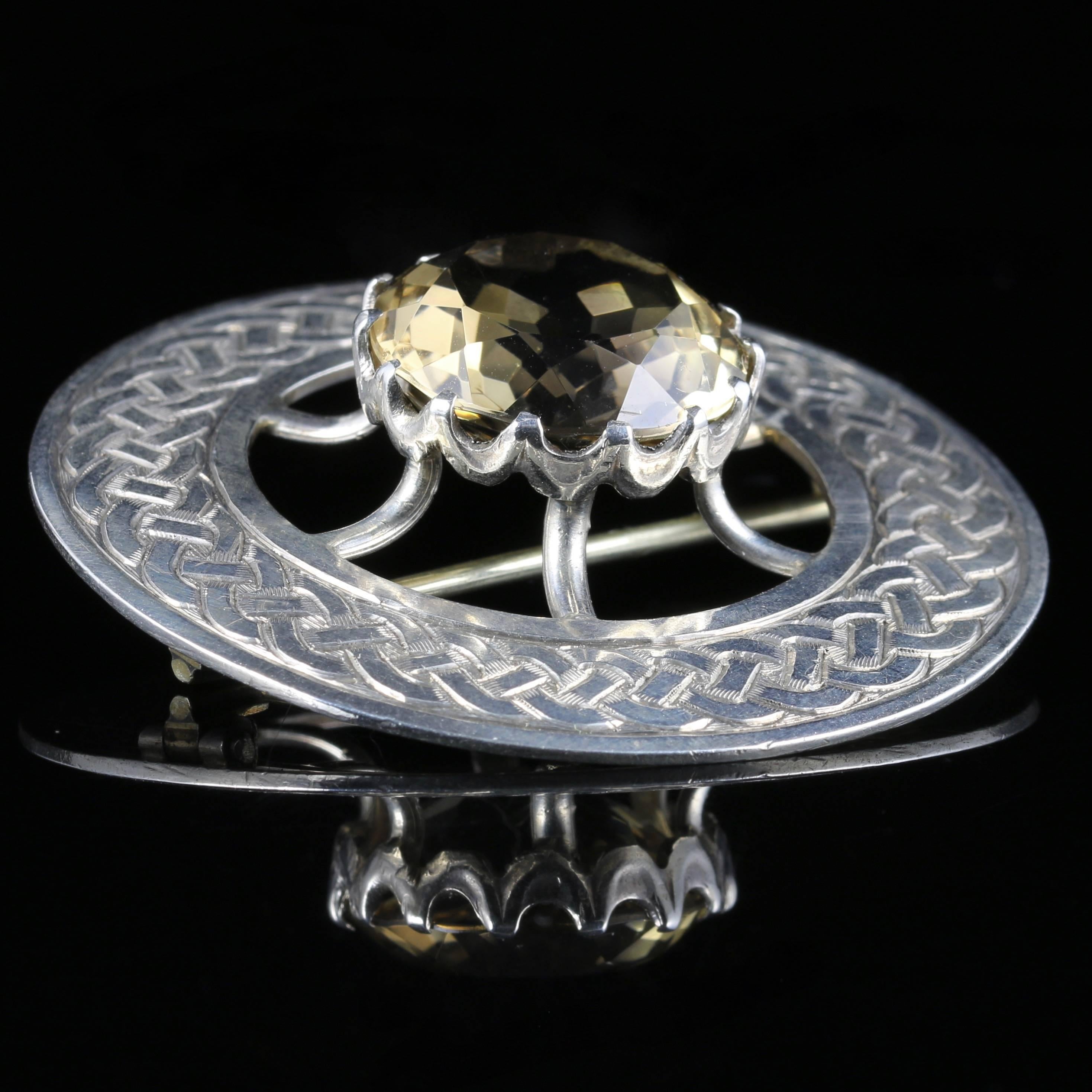 This fabulous Vintage Sterling Silver Scottish brooch is exquisite, set with beautiful workmanship.

A beautiful large brooch that has a lovely Celtic design chasing around the gallery.

The brooch is set with a large central Citrine which is over