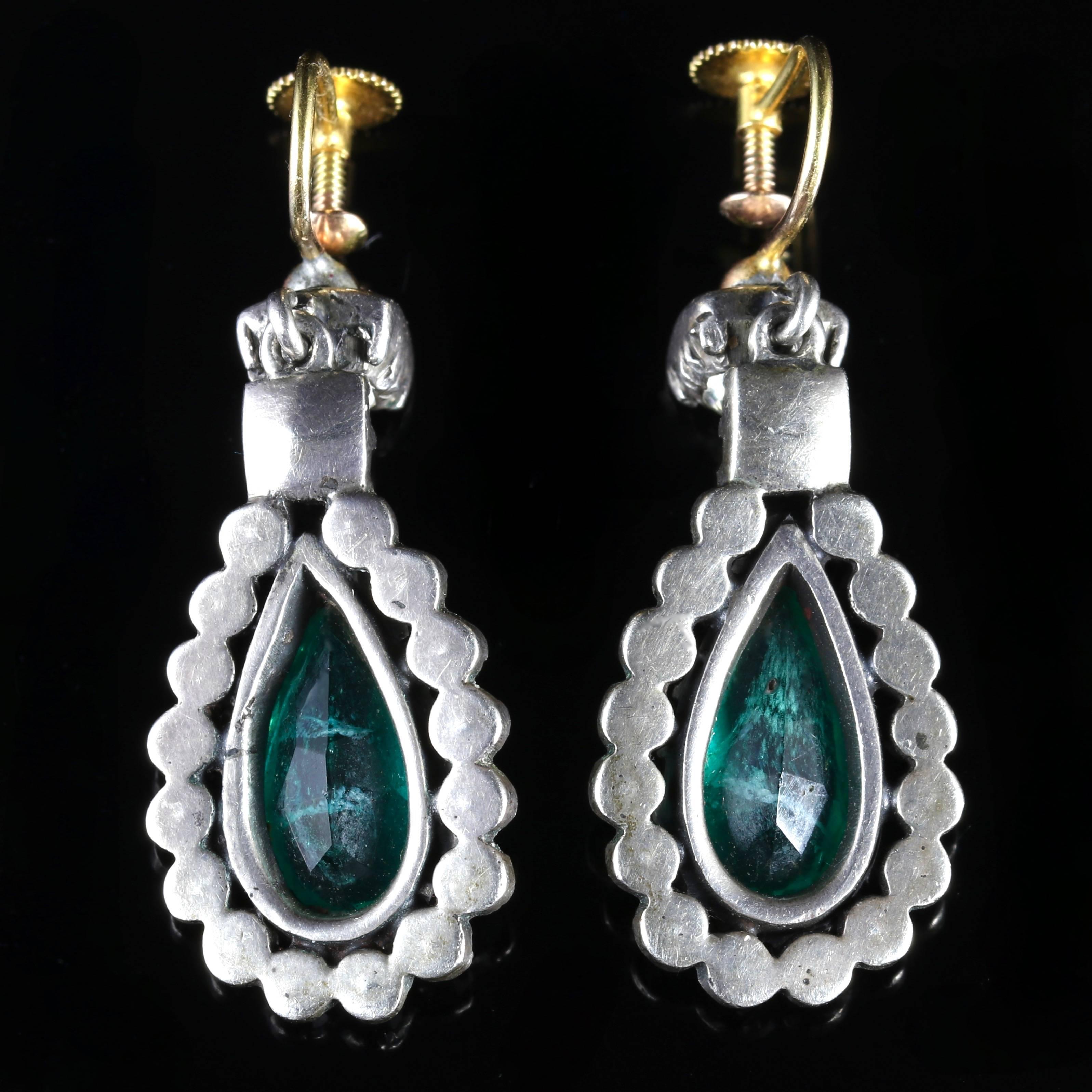 These fabulous Victorian long Silver and Gold earrings are all genuine Circa 1880, set with lovely rich Emerald Green Paste Stones.

A border of outer Paste Stones chase around the outer gallery leading to an old cushion cut Paste Stone at the