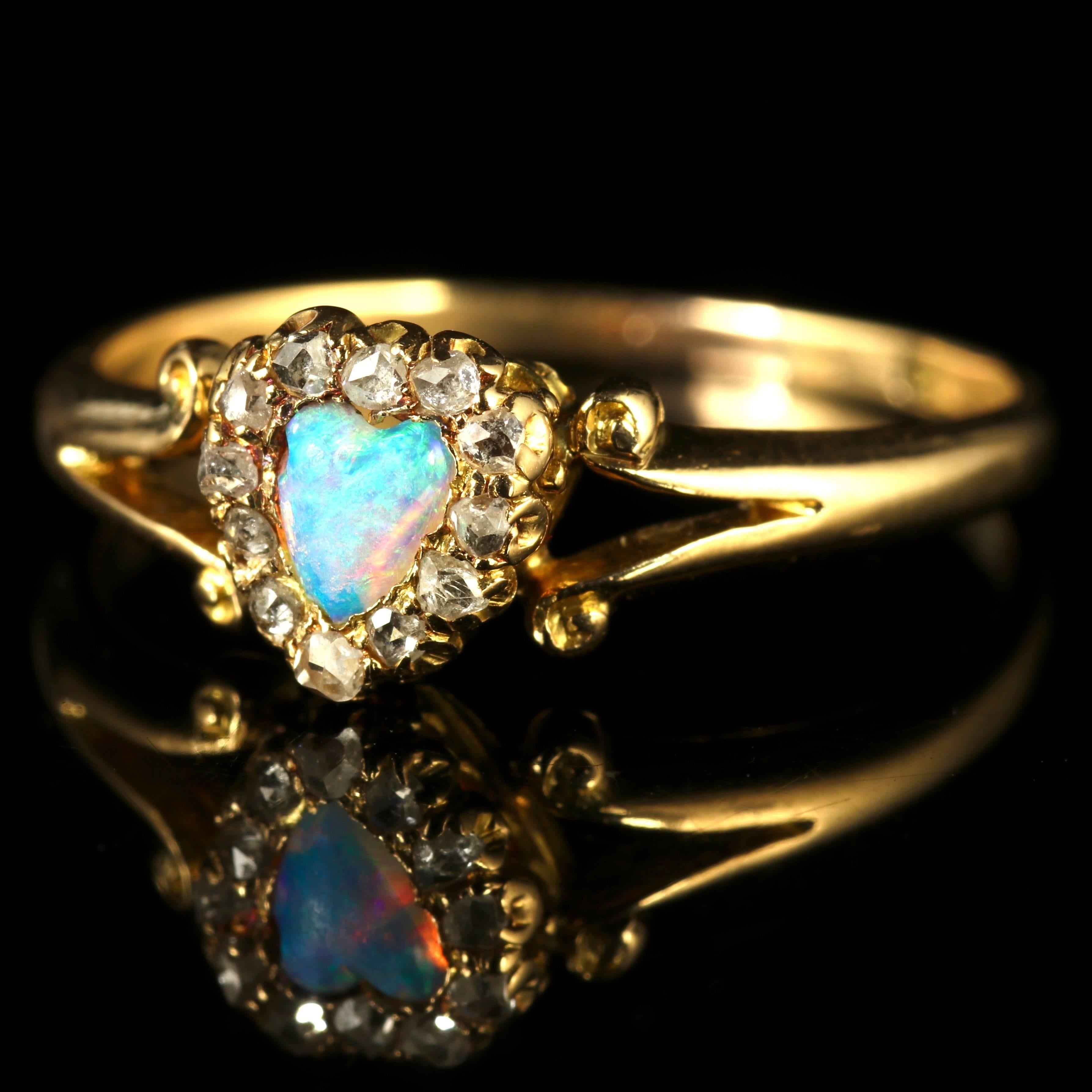 To read more please click continue reading below...

This charming Victorian ring is set in 18ct Gold, a fabulous piece from the 1900s.

Adorned with a central hand carved natural Opal in the centre and a halo of Diamonds chasing around the outer