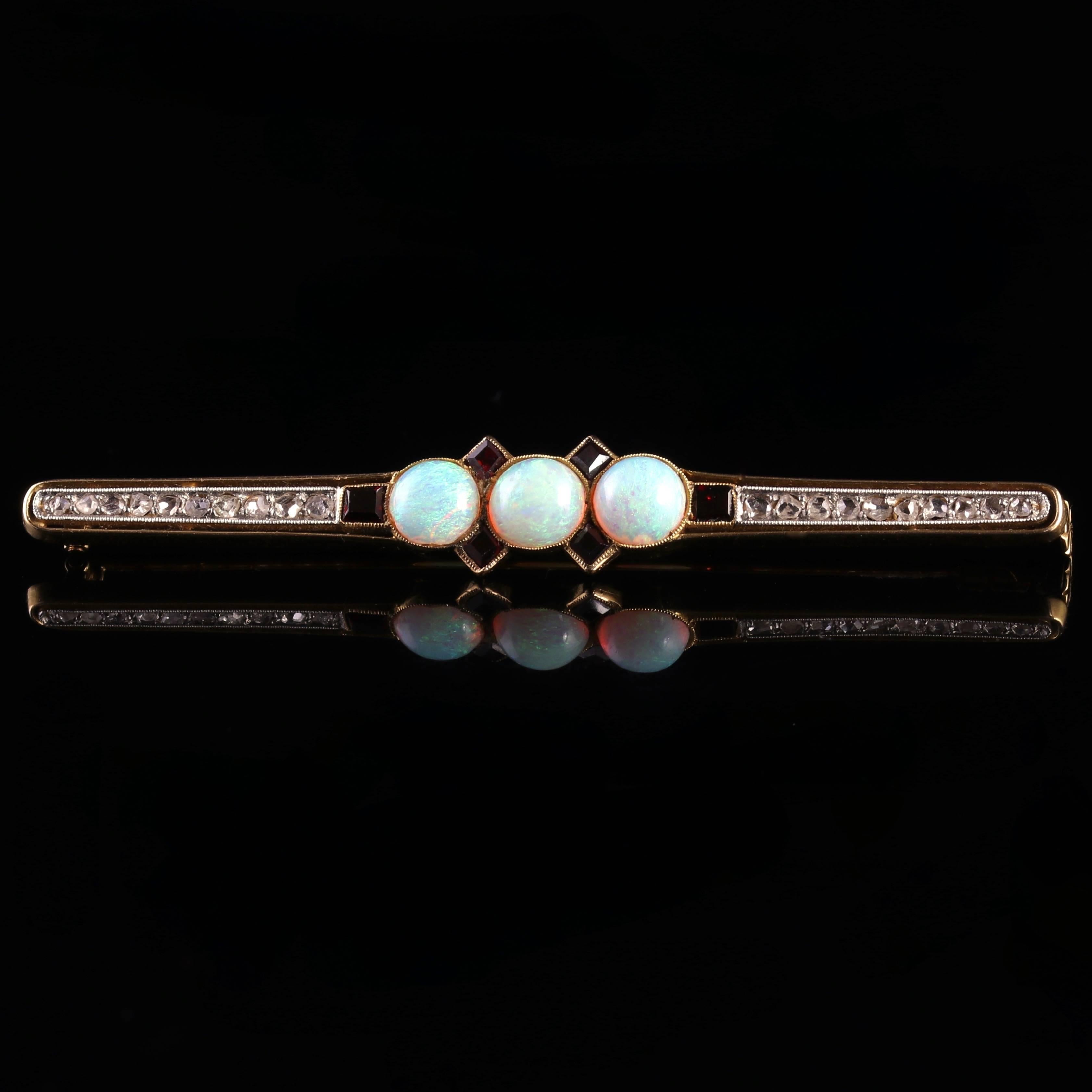 This spectacular 18ct Yellow Gold brooch is adorned with three natural Opals, Garnets and twenty rose cut Diamonds.

This lovely brooch is typical of the Art Deco period, the roaring 1920s.

The lovely natural Opal is a kaleidoscope of rainbow