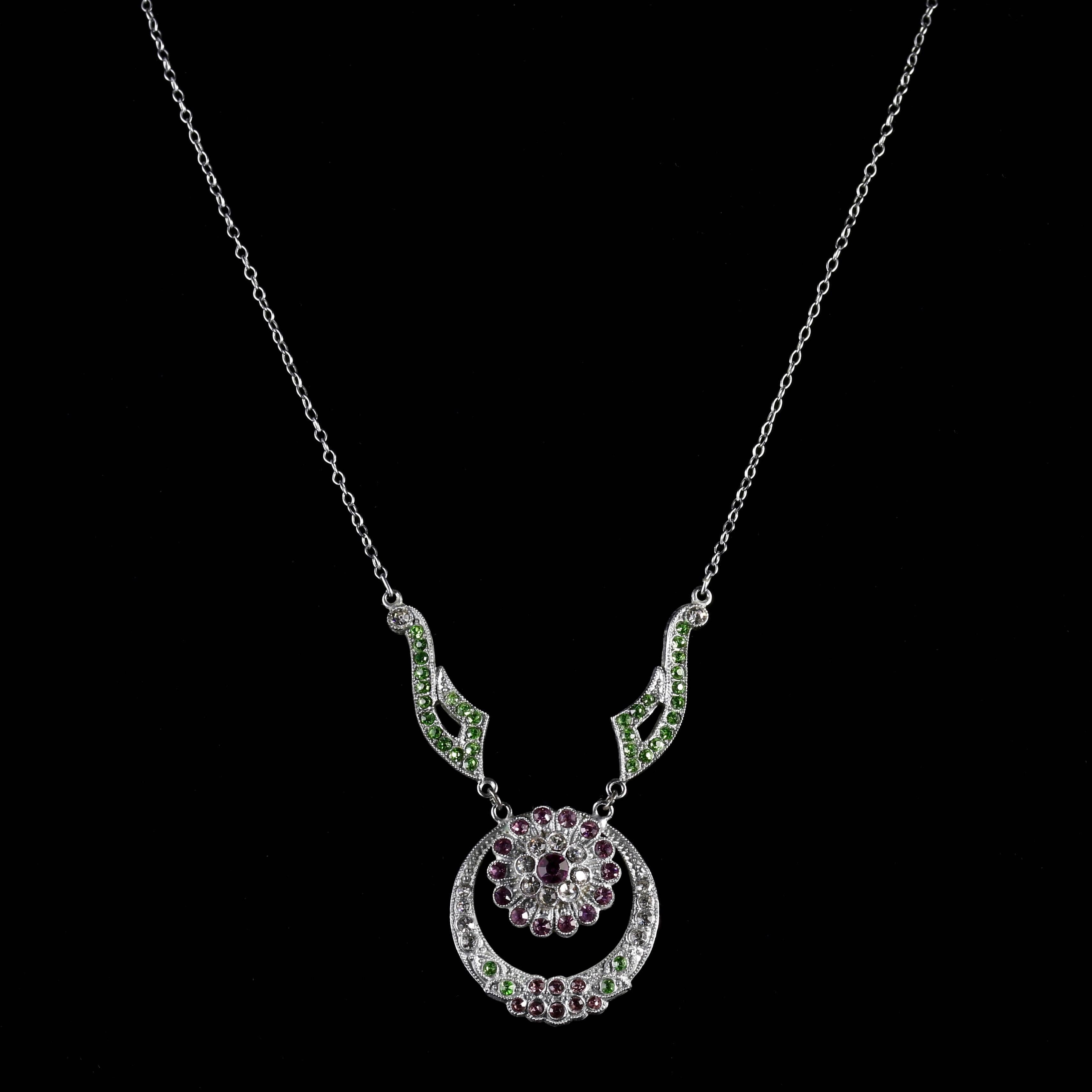 This genuine Victorian Suffragette necklace is set in base metal and is truly fabulous.

The chain leads to a lovely flower design pendant dropper.

Old cut Paste Stones sparkle just like Diamonds, captivating the allure of natures beauty. 

Paste