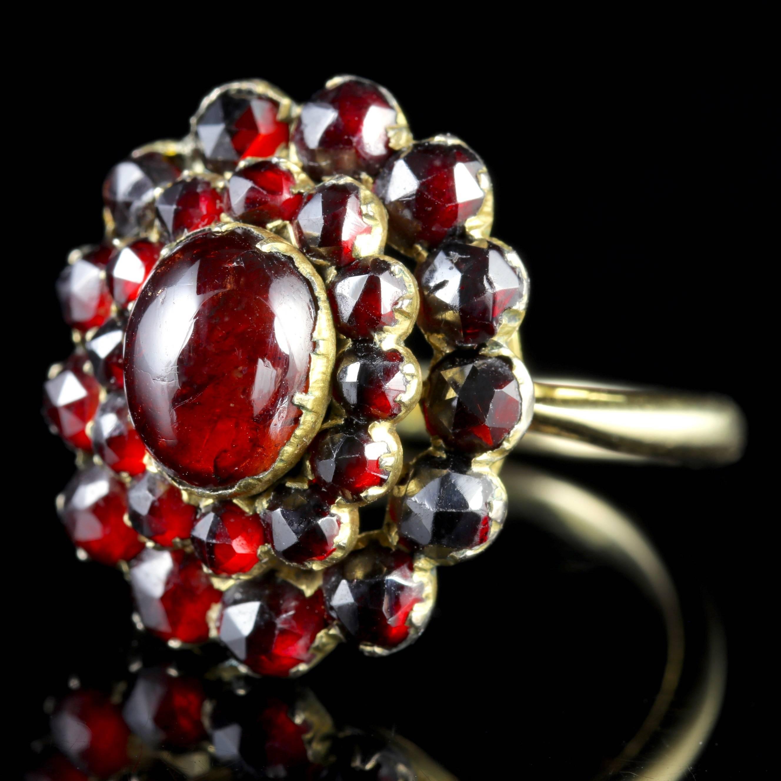 To read more please click continue reading below-

This fabulous antique Victorian large 9ct Gold Bohemian Garnet ring is Circa 1880.

The stunning ring is adorned with a cluster of deep red Bohemian Garnets in layered steps leading to a large