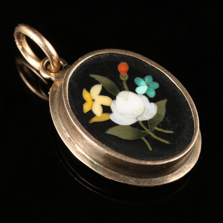 For more details please click continue reading down below..

This lovely little Victorian Pietra Dura Gold locket is Circa 1900.

The front of the locket is set with a gorgeous typical Pietra Dura floral design.

The reverse of this locket holds a