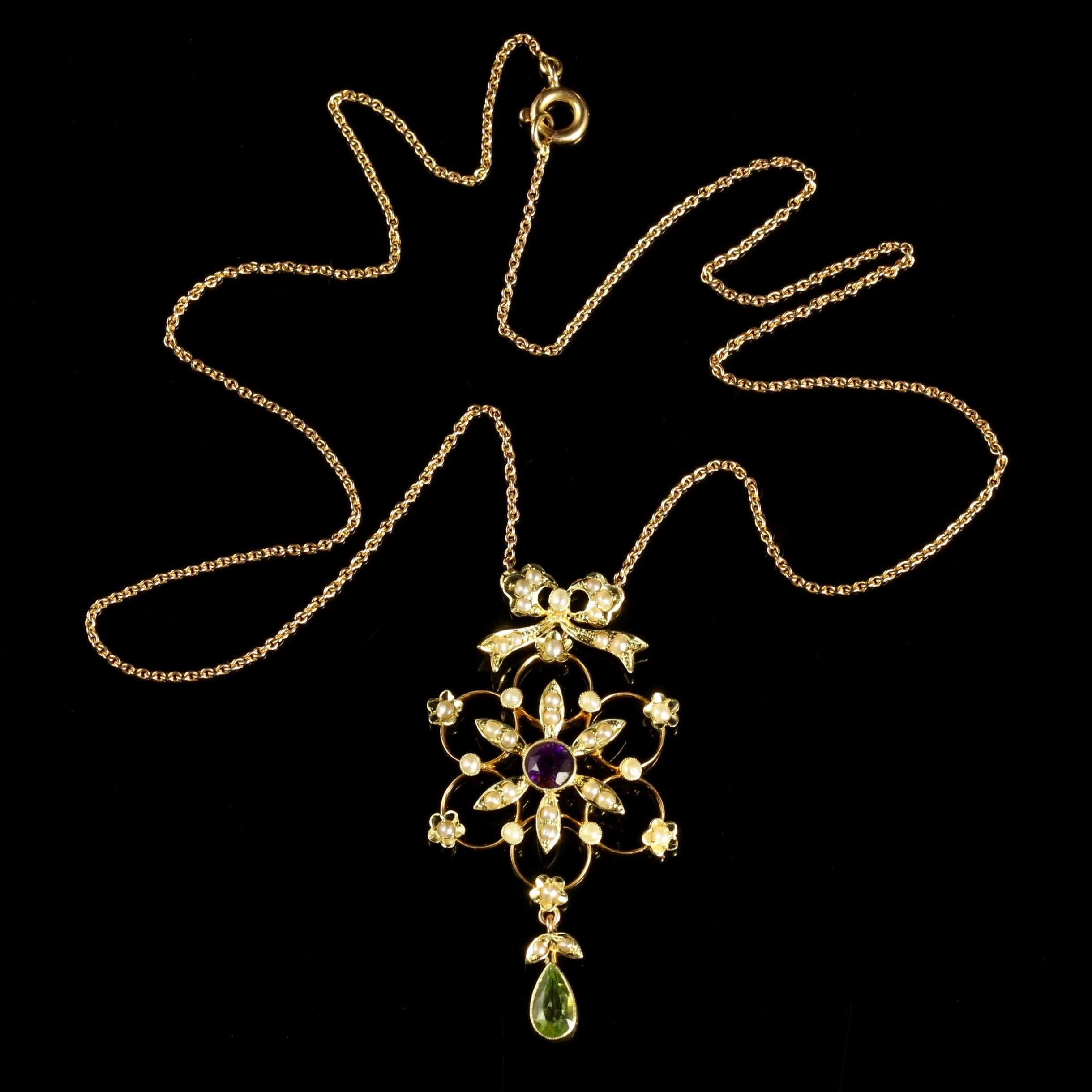 This genuine Victorian antique Suffragette 15ct Gold pendant necklace is Circa 1900.

Set with beautiful Peridots, an Amethyst and lovely Pearls.

The 15ct Yellow Gold gallery is adorned with a Pearl bow top too.

The Peridot is a stone of lightness