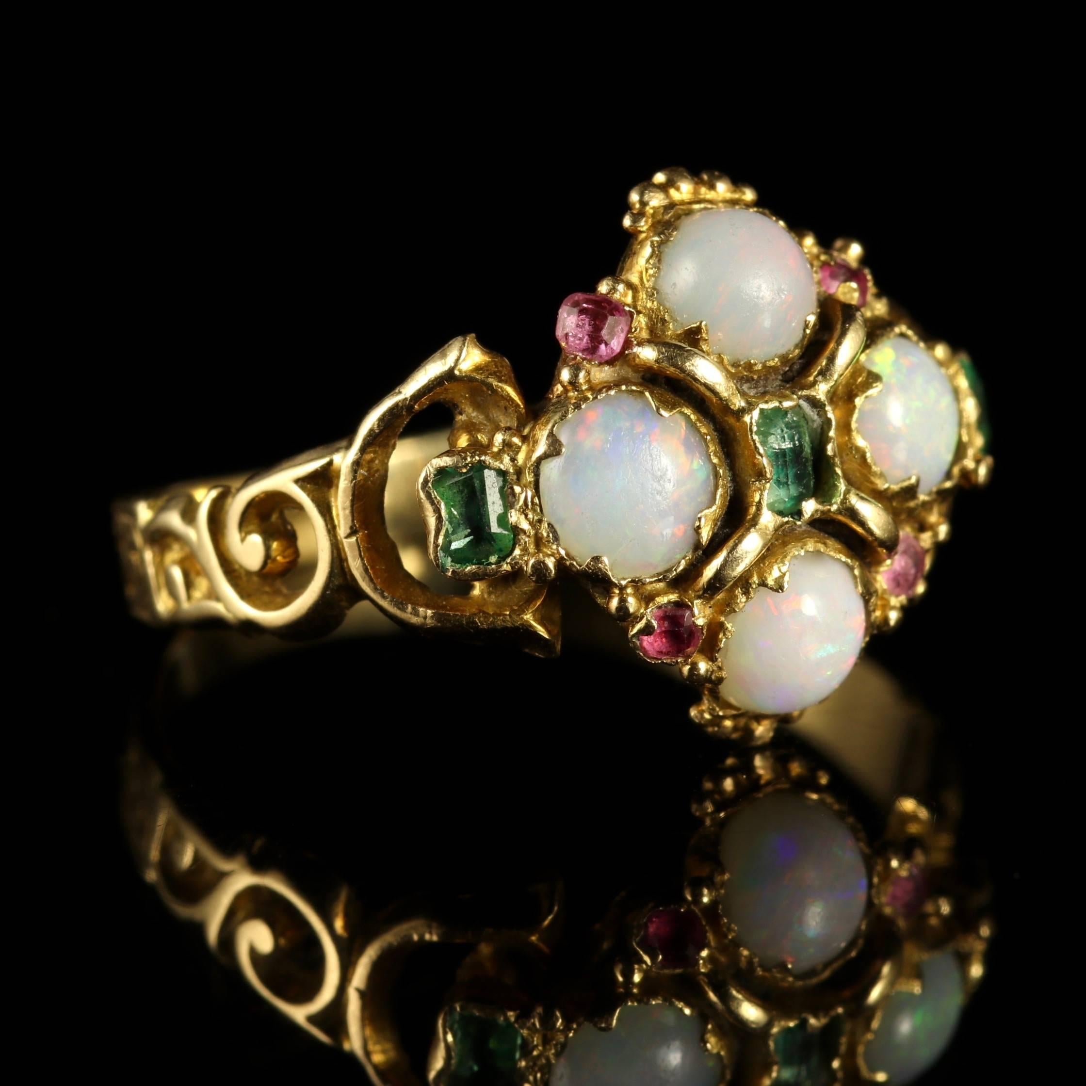 This genuine 18ct Yellow Gold Georgian ring is set with Opals, Emeralds and Rubies, Circa 1790.

All the colours of the Suffragette movement are set into the gallery however this is a Georgian piece.

Due to its age, Georgian jewellery is quite