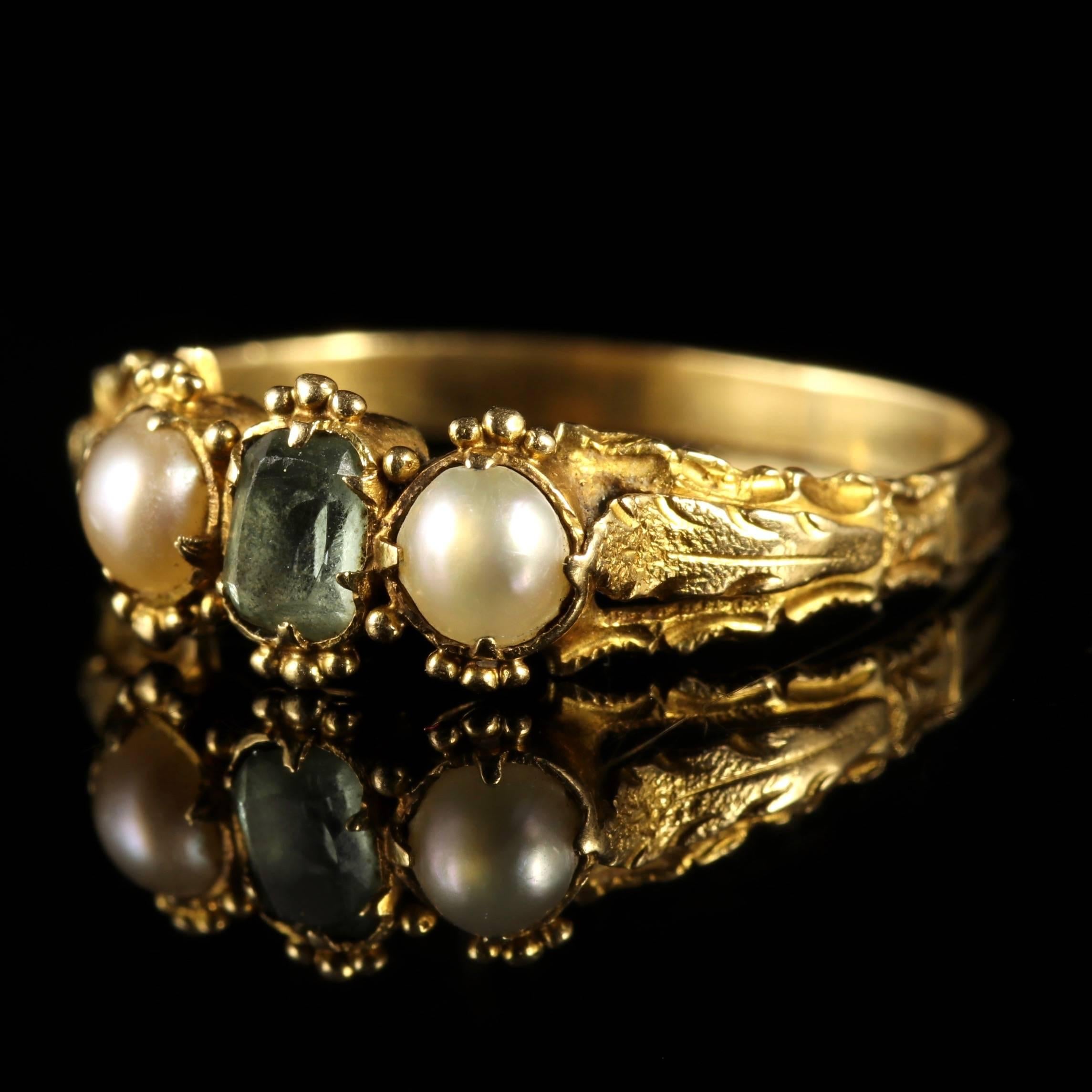 This fabulous 18th century Georgian ring is set with green Tourmaline and Pearls, modelled in 18ct Yellow Gold, Circa 1780.

A trilogy of beautiful gemstones that compliment each other superbly.

Due to its age, Georgian jewellery is quite rare,