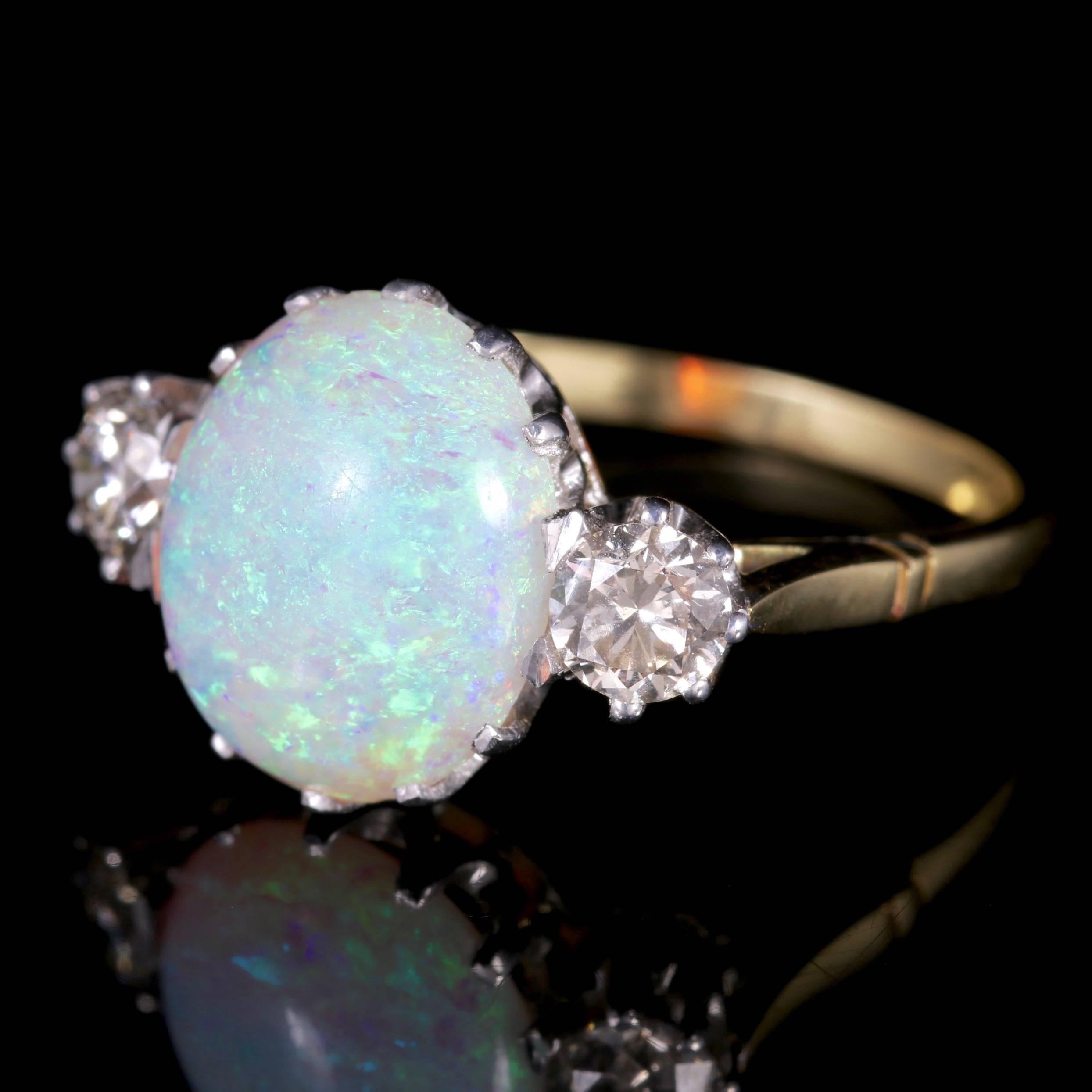 This fabulous natural Opal and Diamond trilogy ring is set in 15ct Gold, Circa 1900.

The central Opal measures 5ct.

The natural Opal is a kaleidoscope of rainbow colours shimmering and changing colours with the light. They radiate a myriad of