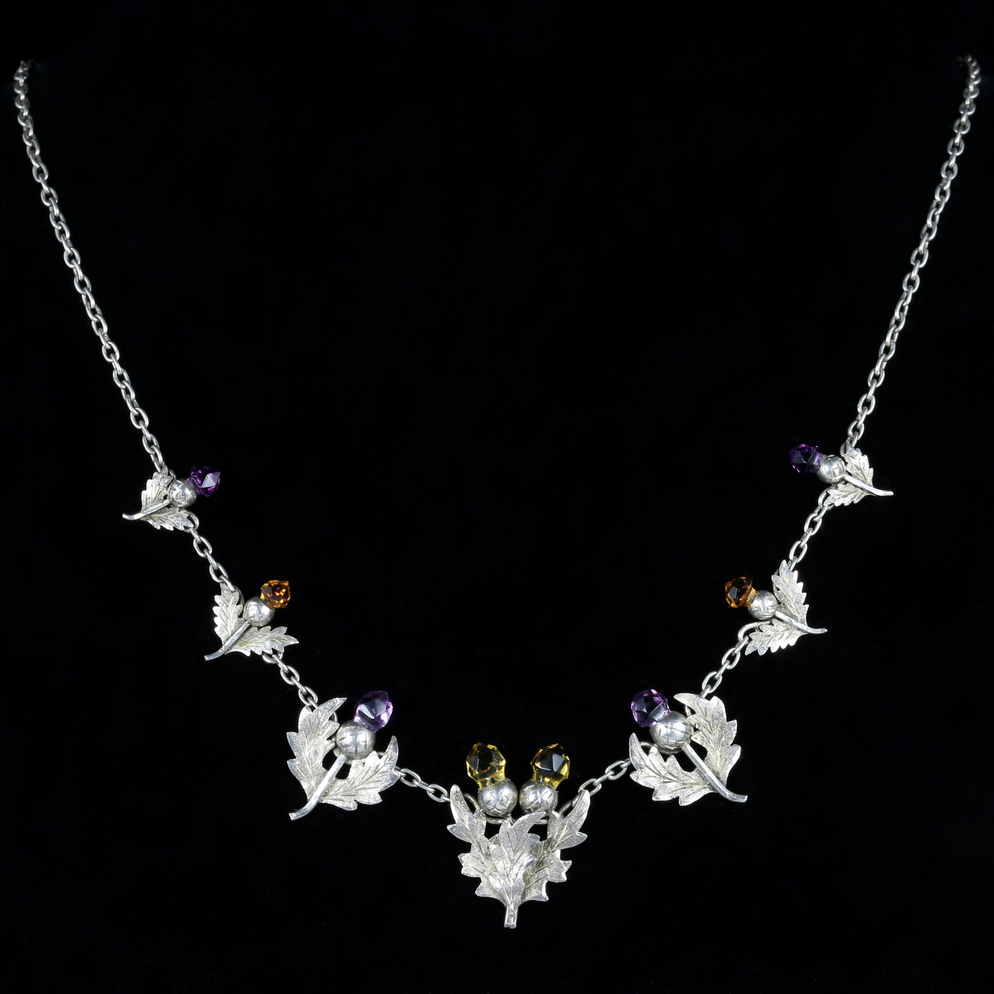 For more details please click continue reading down below...

This fabulous antique Scottish Silver necklace is genuine Edwardian, dated Birmingham 1906.

7 beautifully designed Silver thistles make up this lovely necklace, adorned with Citrine and