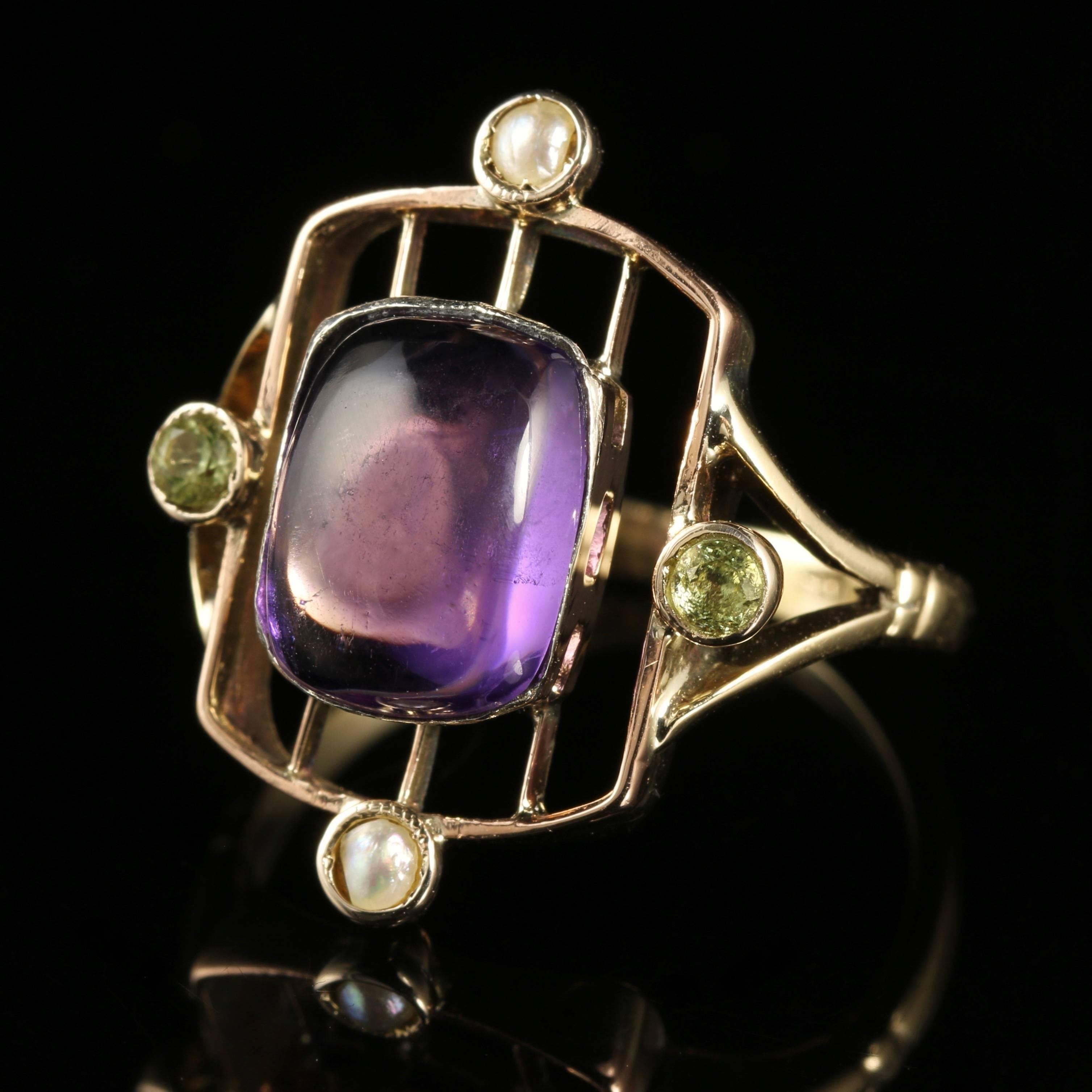 For more details please click continue reading down below...

This genuine Victorian 9ct Gold Suffragette ring is Circa 1900

Set with a beautiful 3.80ct cabochon cut Amethyst in the centre, with 2 lustrous Pearls above and below, and 2 Peridots