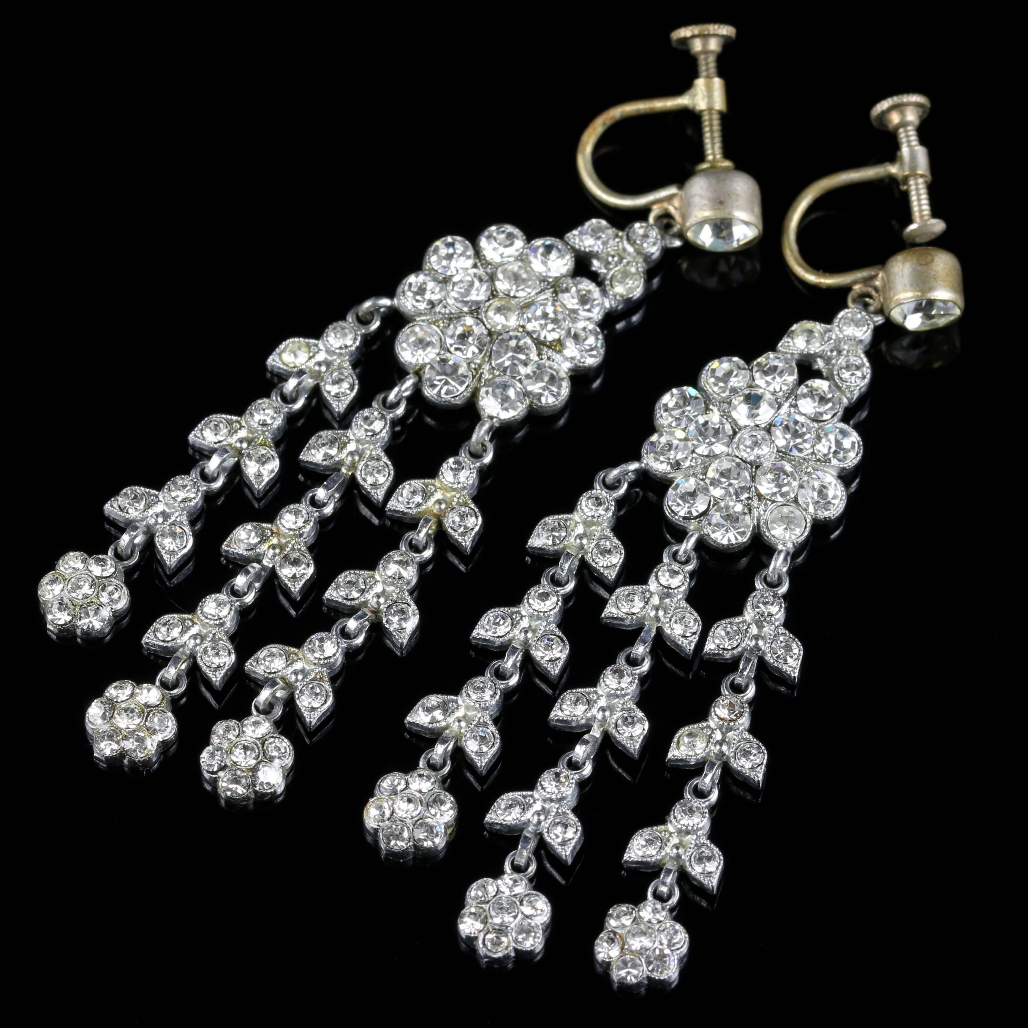 For more details please click continue reading down below...

These are a fabulous pair of long Paste earrings set in white Metal.

Set with a large Paste stone at the top which is 0.50ct in size.

A large cluster of Paste stones then lead down to 3