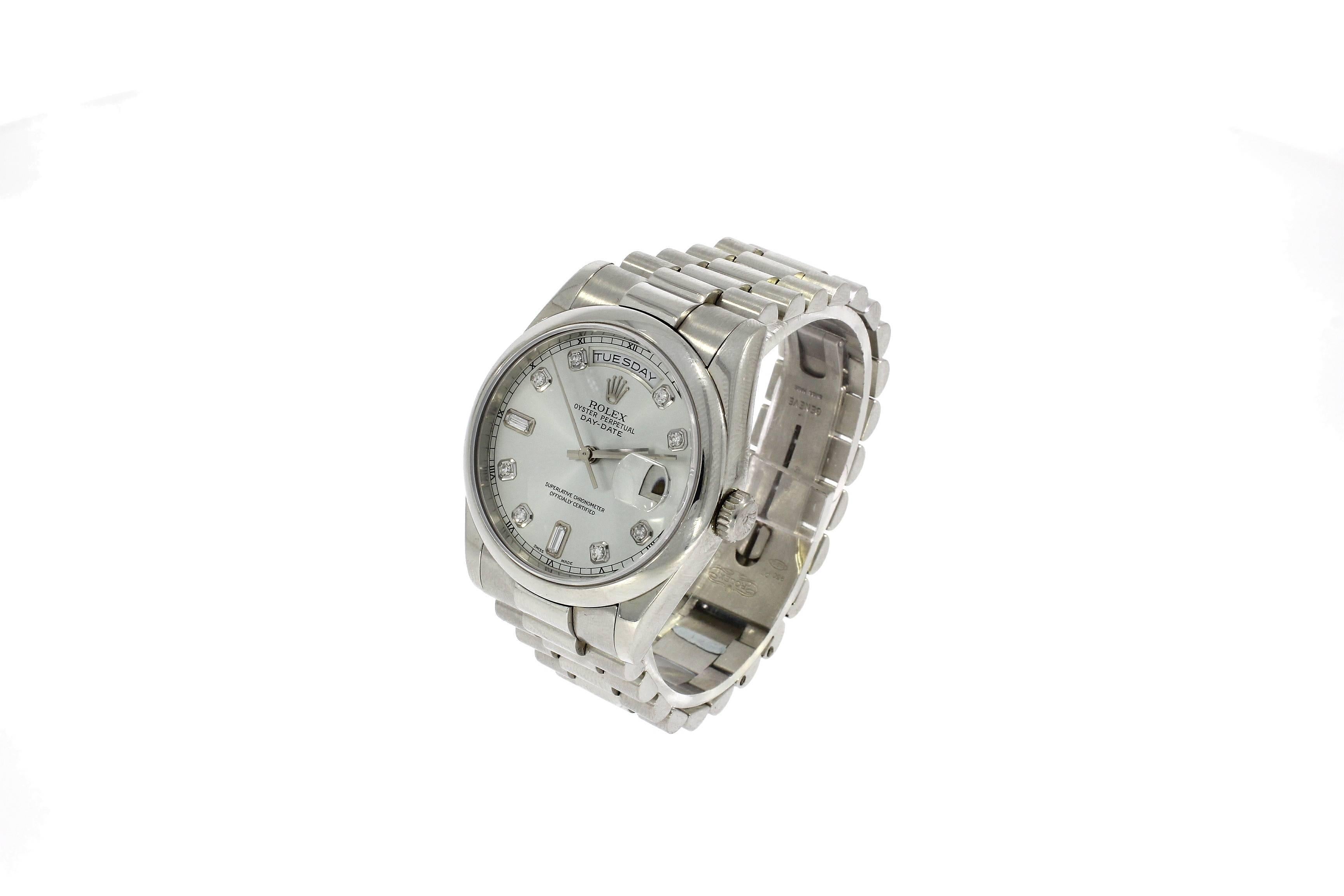 This is a Pre-owned Rolex Day Date. 36mm, Platinum Case, Silver and Diamond dial, Platinum signed bracelet, Powered by a Automatic movement. Circa 2000. Case serial reads P272***

Rolex Day-Date 118206 the platinum version of the Rolex President,