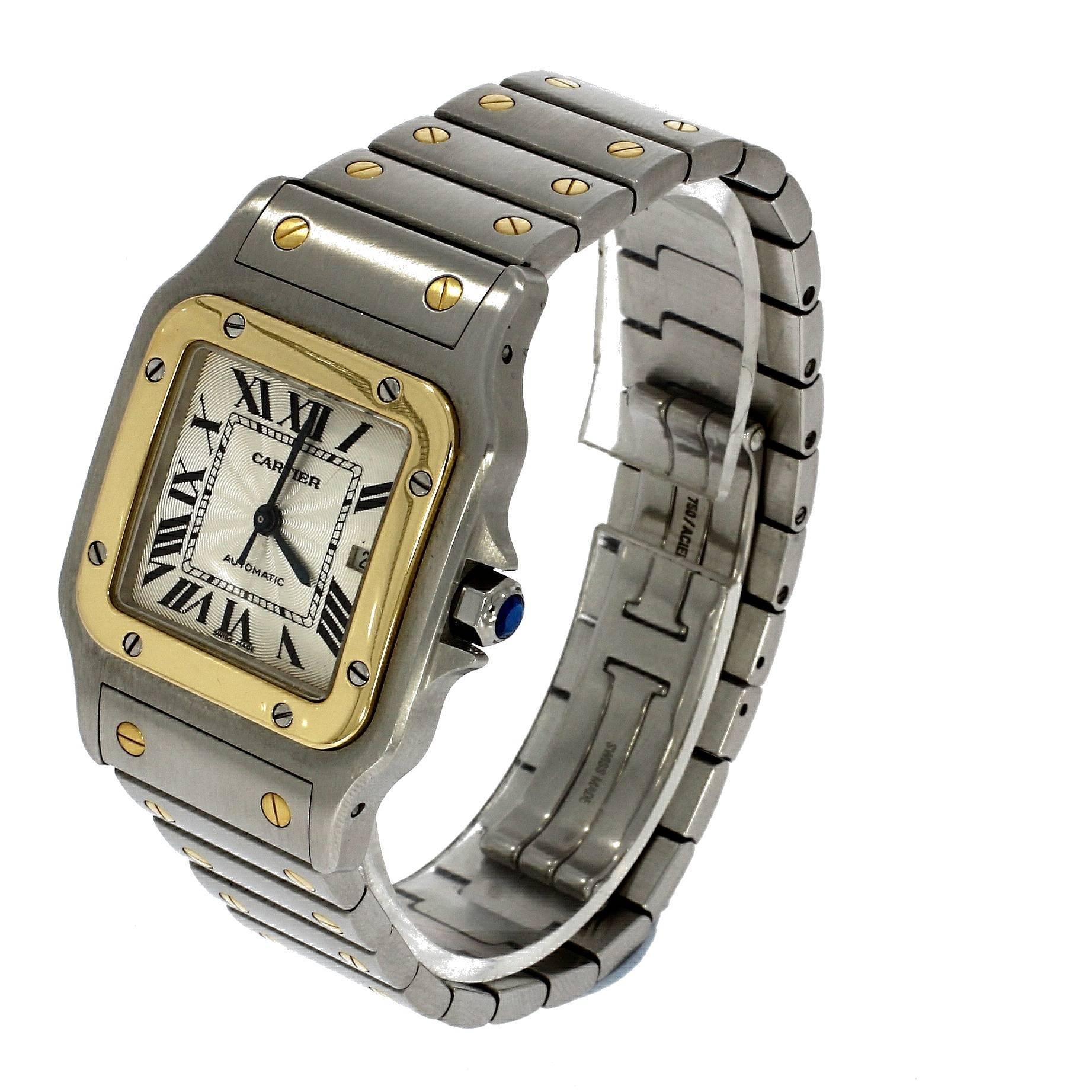 This pre-owned Cartier Santos, has a 32mm Steel case. Fitted with a Guilloche Ivory dial. A Signed bi metal bracelet. With an Automatic movement. Serial number reads: 9216XXXX

The Cartier Santos was designed in 1904 and was one of the first modern