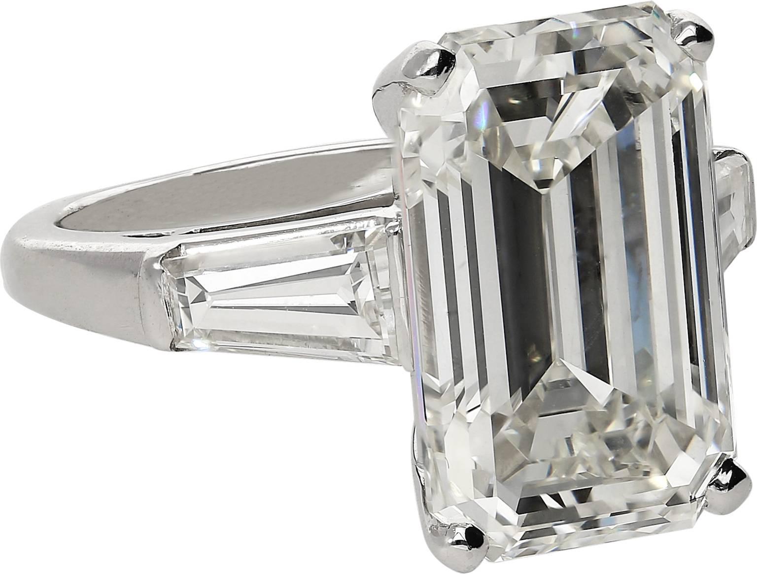  GIA Certified Natural 10.03 Carat Emerald Cut elongated engagement ring. Set in Platinum and shouldered by two Tapered Baguette Cut Diamonds, the diamond ring is. GIA certified as 