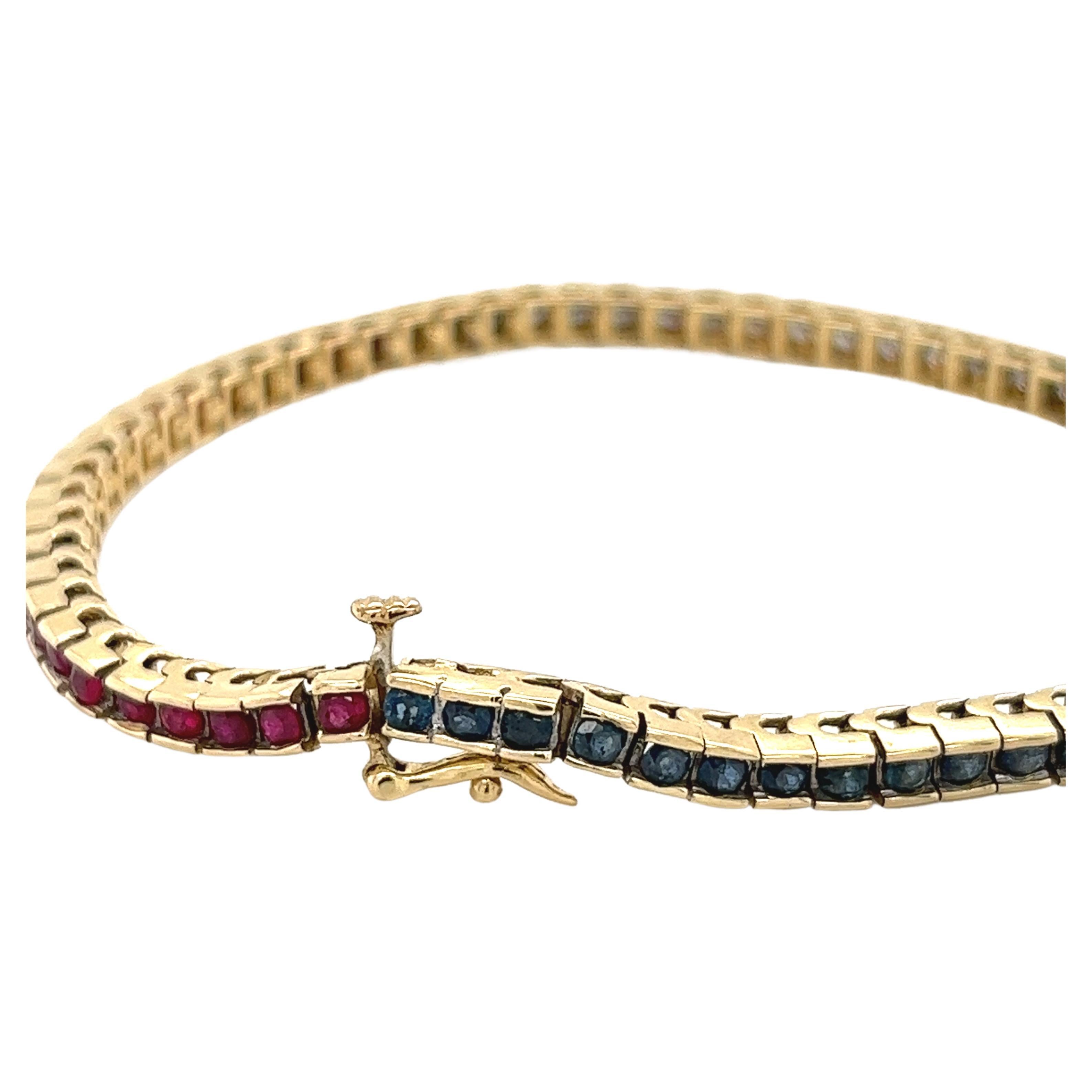 Natural diamond, ruby, and blue sapphire flexible tennis bracelet mounted in a half bezel tension setting. Red ruby, white diamonds, and blue sapphires create this patriotic USA flag-colored bracelet. Set in 14k solid gold, hypoallergenic, and a