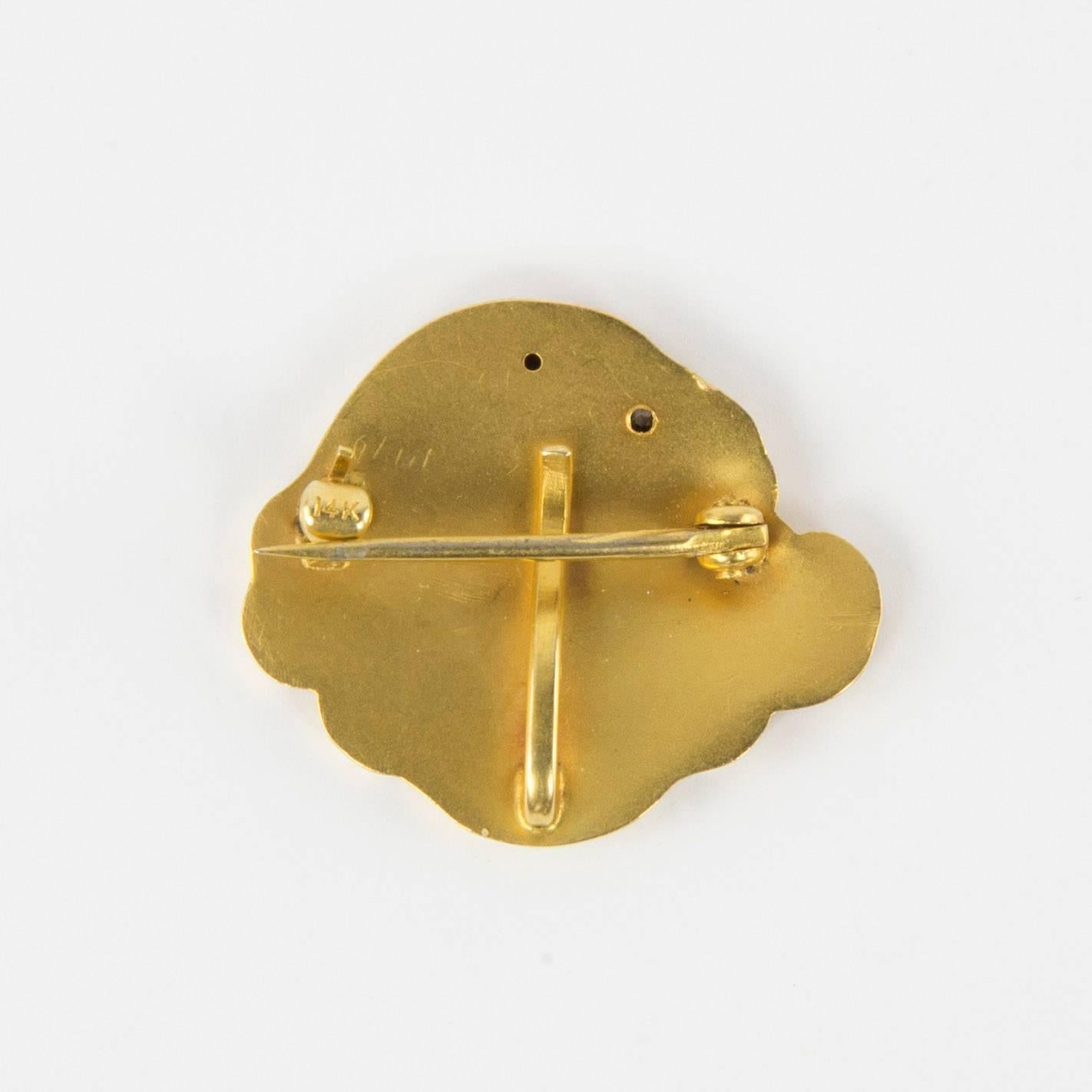 Art Nouveau pin and watch holder featuring a gaze of a glamorous lady, a Gibson Girl with a diamond in her hair; in a bas-relief chased profile is lifted up to a future of prosperity and sunshine. Matte Gold; Clasp marked: 14K; circa 1900; A great