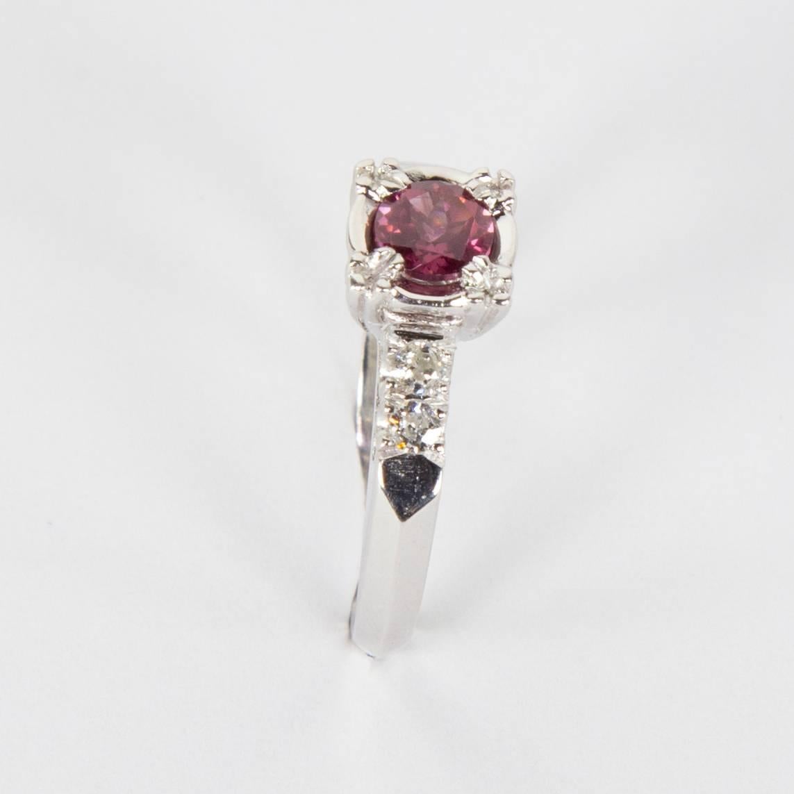 Beautiful Solitaire Engagement Ring centering a Pink Tourmaline, approx. 0.45 carat; enhanced with Diamonds on shoulders of Platinum mounting. Marked: PLAT; Ring size: 6.5; Complimentary ring resizing available. A Special and Timeless engagement