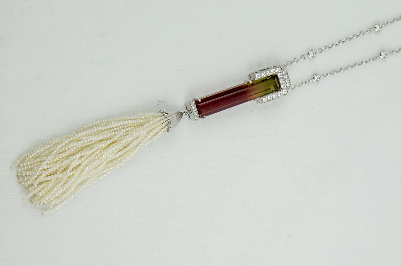 Sautoir Necklace features a fine quality Rectangular Bi-color Tourmaline, enhanced with micro set Diamonds in gallery mounting, suspending a tassel composed of 40 strands of Akoya Keshi (seed) Pearls; the chain is inter-spaced with round cut