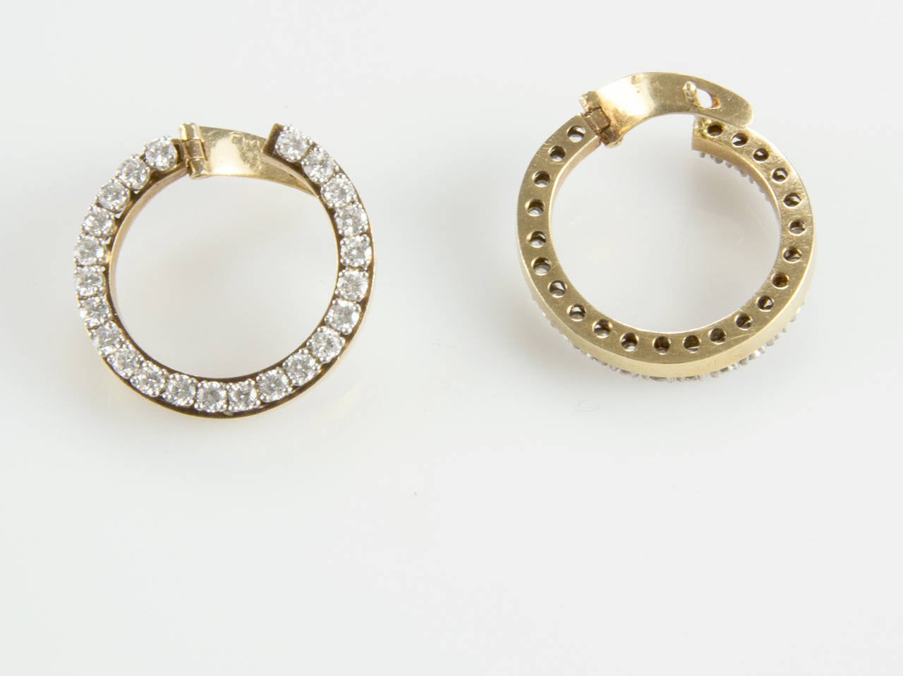 Chic and sparkling, these diamond earrings feature round diamonds set in an open circle design of 14k yellow gold; approx. 1.38 total carat weight; G/H color. An elegant accent to any ensemble!
