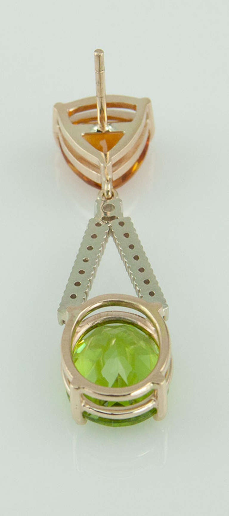Beautiful Drop Dangle Earrings each set with a Triangular facet cut Citrine suspending a Bar of Diamonds and an oval facet cut Peridot; hand made in 14k white gold; approx. total weights: two Citrine 4.10ct, two Peridot 4.80 and thirty-two diamonds