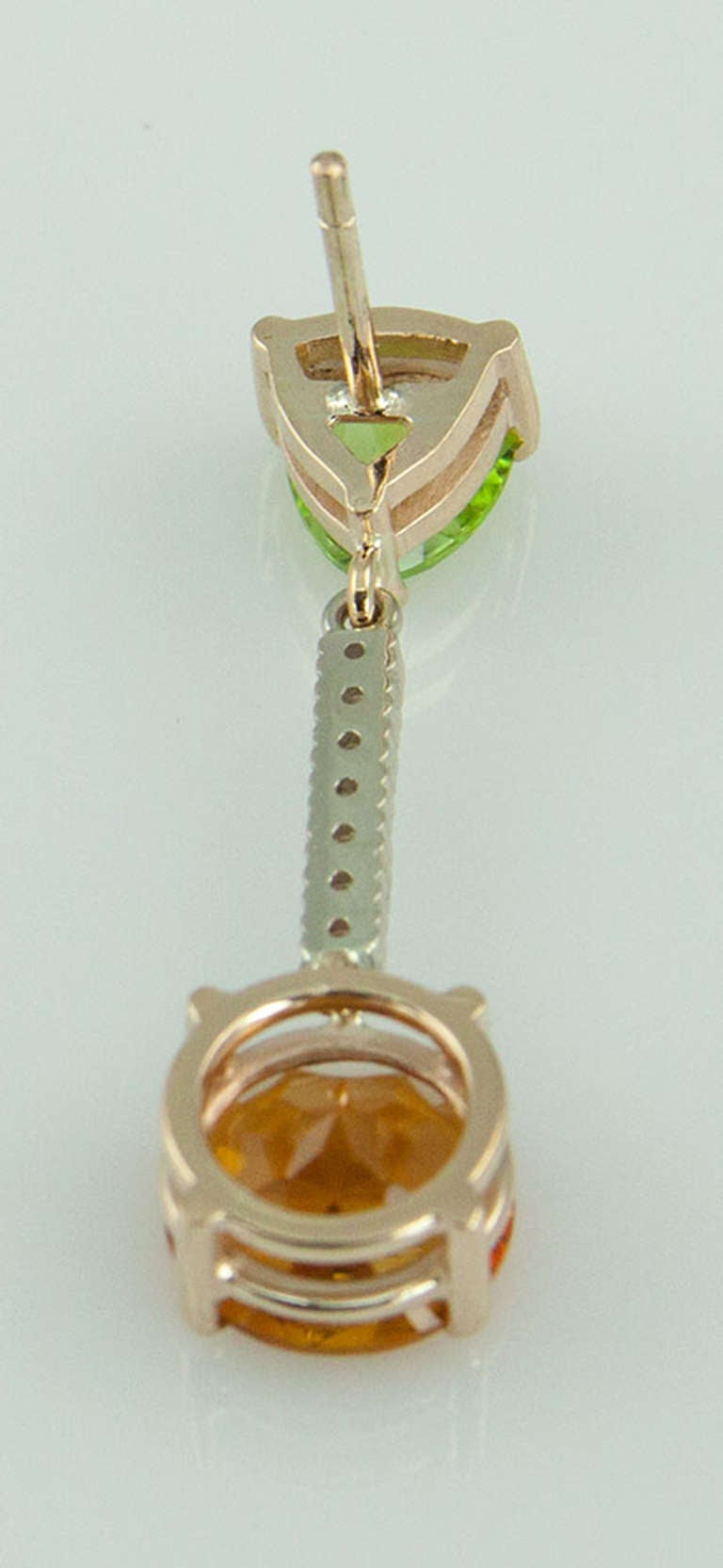 Beautiful Drop Earrings each set with a Triangular facet cut Peridot suspending a Bar of Diamonds and a round facet cut two Citrine; hand made in 14k white gold; approx. total weights: two Peridot 1.60; Citrine 4.9ct and fourteen diamonds .20ct.