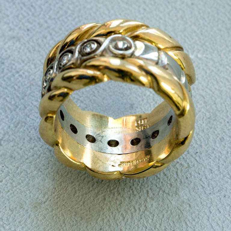 Signed Walter Schluep Gold Diamond Love Ring Band #O 481; all handmade in 18k yellow gold center is bezel set with eleven round brilliant-cut diamonds, weighing approx. .55ct; approx. Ring size: 7; Marked: 18K SCHLUEP plus his trademark signature;