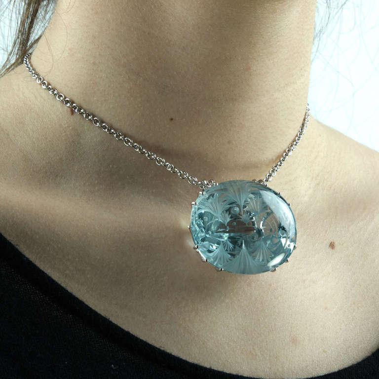 Necklace features a Beautiful deeply engraved oval Blue Topaz set in a handmade 14k white gold gallery-style setting. Approx. size and weight of stone: 43mm x 36mm x 21mm; 260ct. Classic and Timeless! Blue Topaz is a symbolic of love and fidelity.