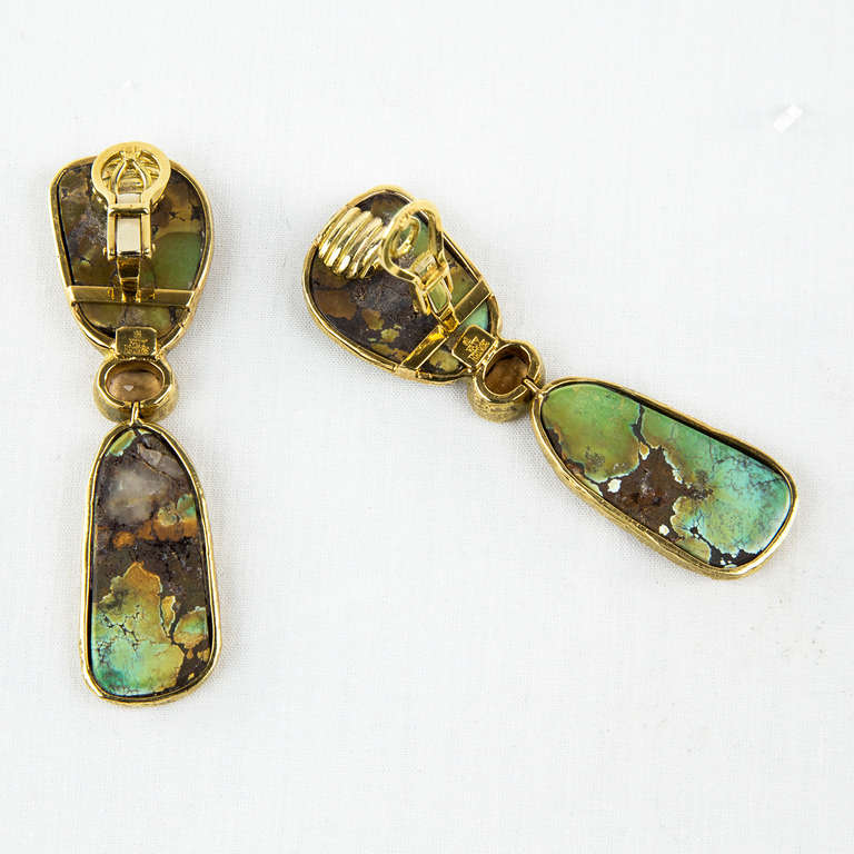 Bold and Beautiful! 18kt yellow Gold, Chinese Turquoise and Brown Zircon movable Drop Earrings by Katy Briscoe; the textured mount bezel-set with 2 free form Chinese turquoise, further set with an oval-cut brown zircon; approx length of each