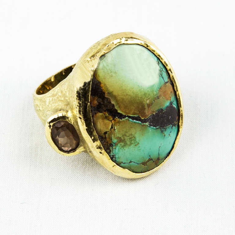 Bold and Beautiful! 18kt Gold, Chinese Turquoise and Brown Zircon Ring, the textured mount bezel-set with a Chinese turquoise, measuring approximately 30  x 22.5 mm, flanked by oval-cut brown zircon, 35.1 gm, size 7, signed and marked: Katy Briscoe