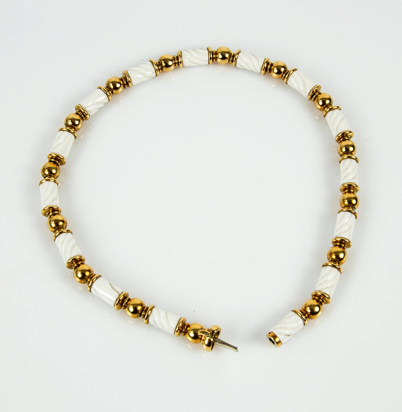 Beautifully crafted Necklace in 18k Yellow Gold inter spaced with 15 White Ceramic beads; Necklace measures approx. 15 5/8