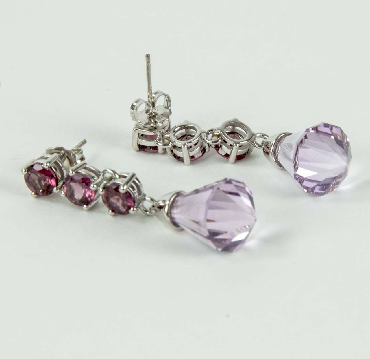 Simply Beautiful and Elegant Dangle Earrings! Each faceted Cone-shaped Rose de France Amethyst, weighing approx. 7.30ct (14.60Tctw) is suspended from a flexible stem, prong set with 3 Faceted Garnets, ending with a faceted cone-shaped Amethyst.