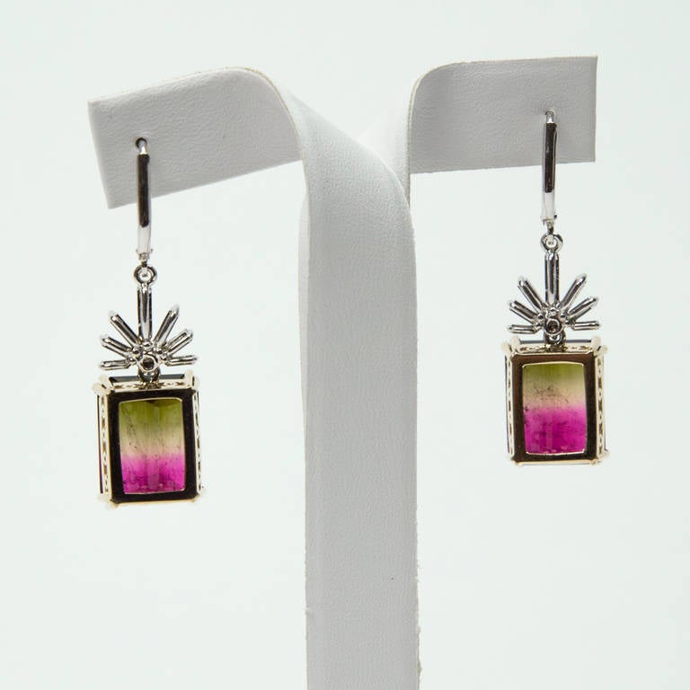 Fan shaped diamond cluster earrings, suspending a step-cut watermelon tourmaline; handmade 14k white and yellow gallery mounting; 24.80ct total tourmaline weight; 1.20ct total diamond weight; measuring approx.1.63” long. Beautiful and Timeless!
