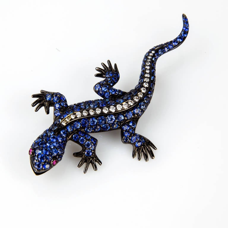 Fabulous blue Sapphire and Diamond Lizard pin Brooch; micro set with diamond-cut sapphires, center of body set with brilliant-cut diamonds, eyes set with red cabochon sapphires. Handmade in 18k white gold; black rhodium finish; marked on back: 750