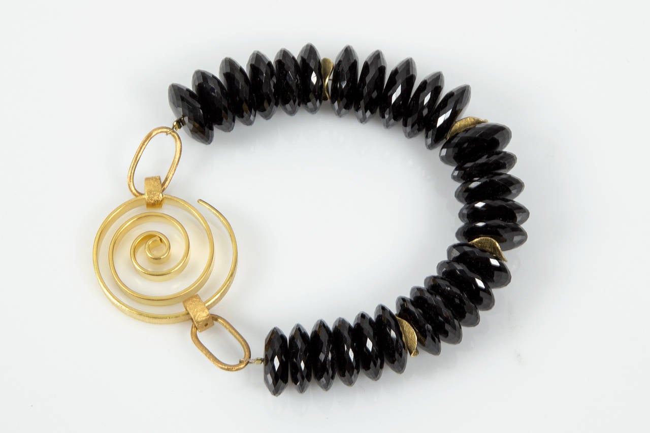 Shimmering High Quality Black Spinel rondelle beads interspersed with Gilt S/S discs and a unique Gilt Sterling Silver clasp give this simple Stunning bracelet Dramatic Flair. Approx. length: 8.75