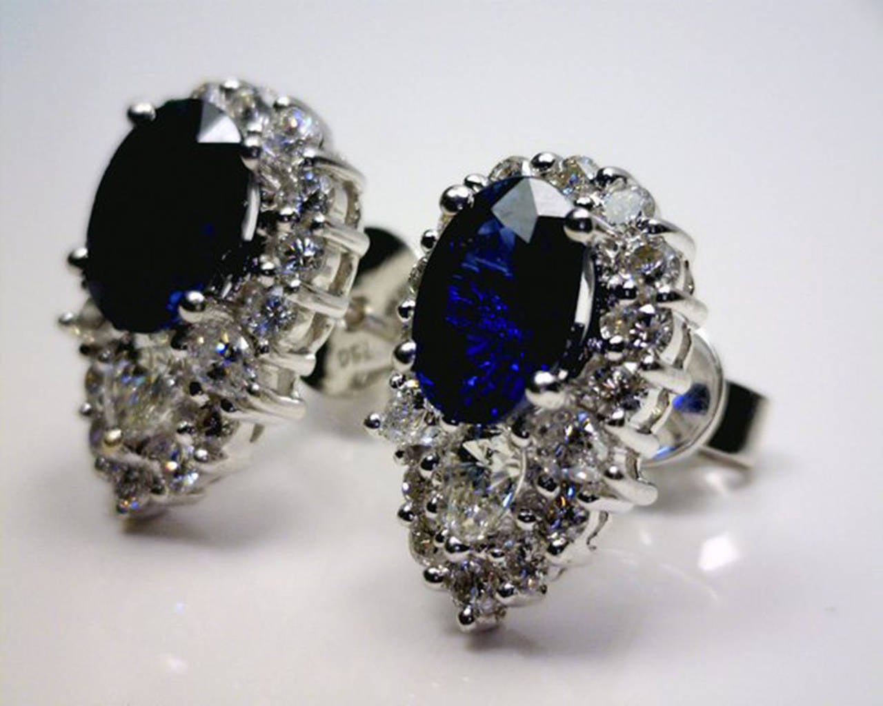 These Modern Earrings have a breathtaking Sparkle to them. Two beautiful oval Sapphires (3.5tcw) are surrounded by pear and round diamonds (1.20tcw) in 18k white gold mounting. Dimensions: 1.5cm long x 1cm wide. Sapphires are 8mm x 6mm. Post with