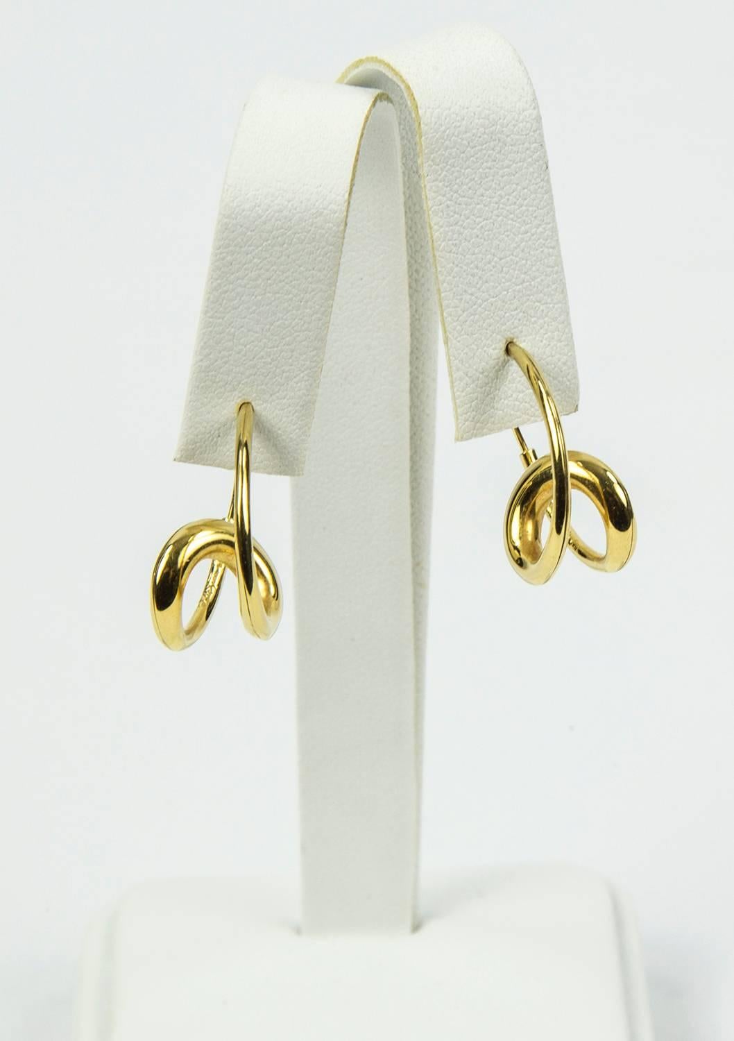 Exquisite handcrafted 18k Yellow Gold Single Loop Hoop Earrings Signed by Renowned Master Metal Smith, Michael Good are a twist on a modern classic. Created completely by hand, the goldsmith uses a hammer to compress and stretch precious metal into
