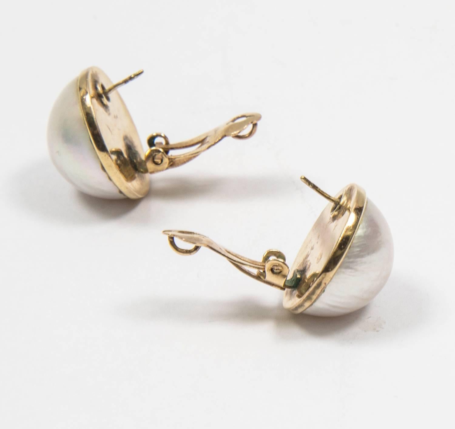 Beautiful Round Mabe Pearl Earrings set in 14kt yellow gold rim, each pearl, measuring approx. 17.5 mm; clip and post backs. Simple, Classic and Timeless! 
