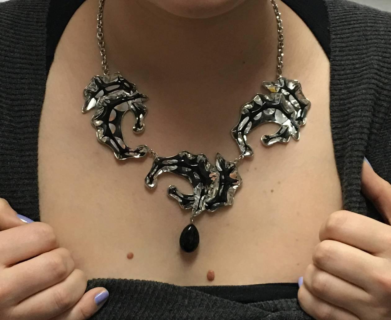 Lalique Stylized Seahorse Sterling Silver Necklace suspending a teardrop onyx; with adjustable Silver chain, ; marked: LALIQUE with French hallmarks; approx. total length: 24; in original LALIQUE box. Chic and Timeless...Illuminating your look with
