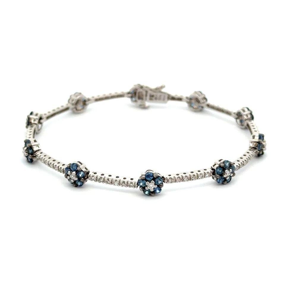 Simply Beautiful! Sapphire and Diamond Gold Link Bracelet. Brilliant Cut Diamond Link Bracelet inter-spaced with Round Flower Blue Sapphires. Securely Hand set with Round Blue Sapphires, weighing approx. 2.50tcw and RBC Diamonds, approx. 0.85tcw.