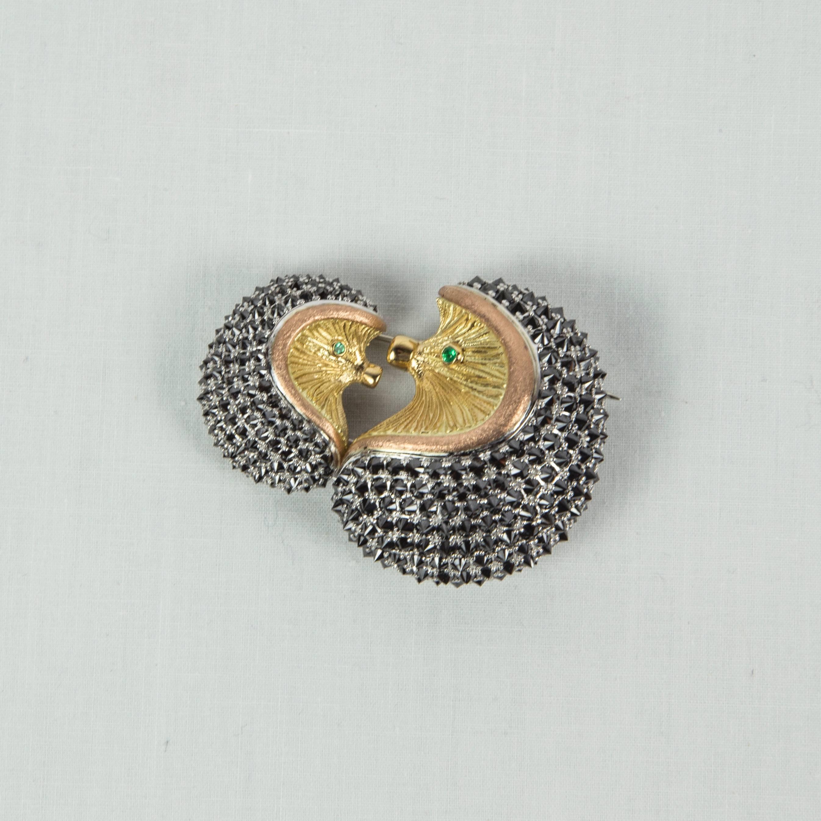 Delightful Mother and Baby Hedgehog Brooch pave set with 260 black diamonds weighing approx. 12.63ct; hand crafted in 18k multi colored white, yellow and rose gold; Emerald set eyes. Approx. size: 2” x 1.5”. Approx. weight: 43.07gm. A perfect
