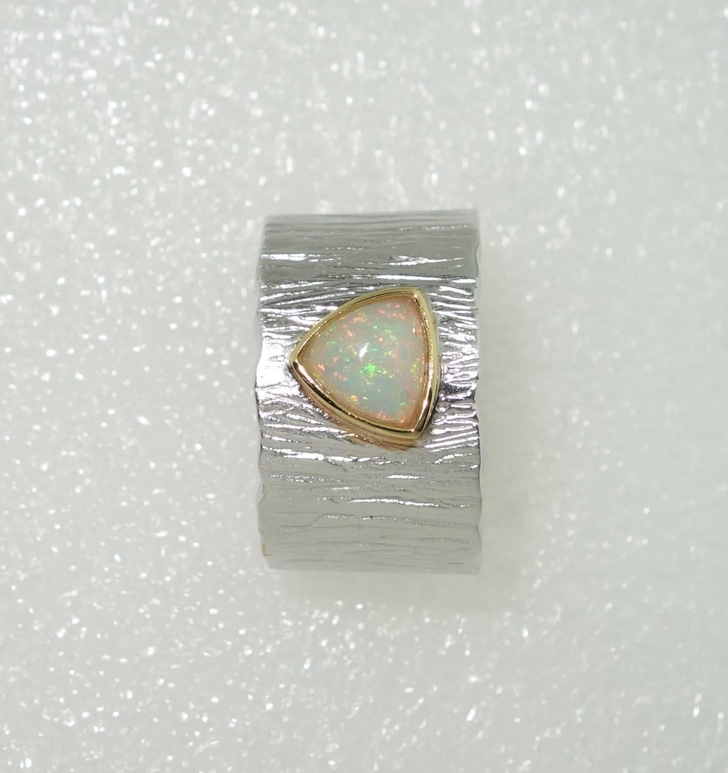 Beautiful solitaire ring featuring an Ethiopian Opal; approx.  0.81 Carat; Sterling Silver Tarnish-resistant Rhodium mounting; Size 9; we offer complimentary ring re-sizing. Classic and Classy…illuminating your look with Timeless Beauty! 
